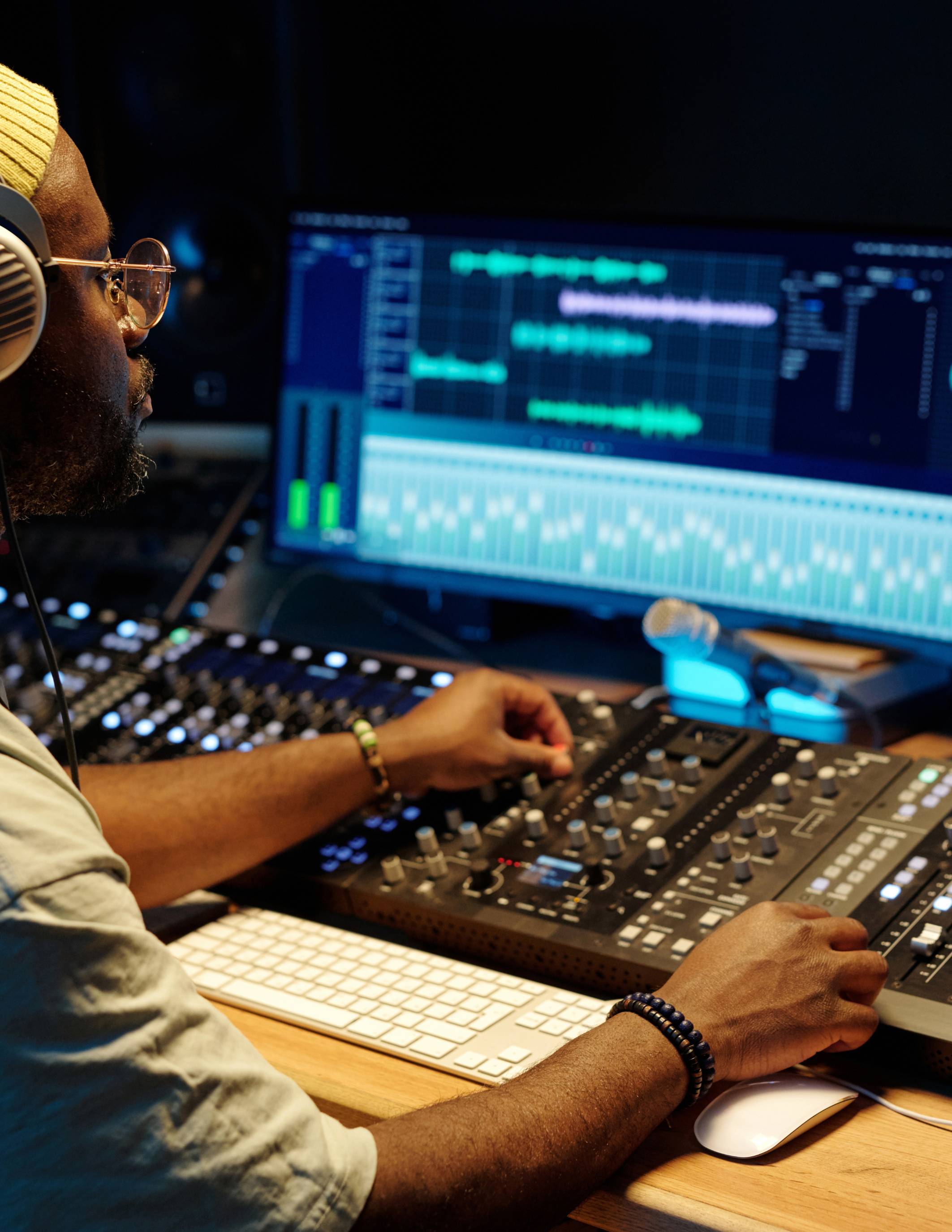 a man at a desk using digital editing software