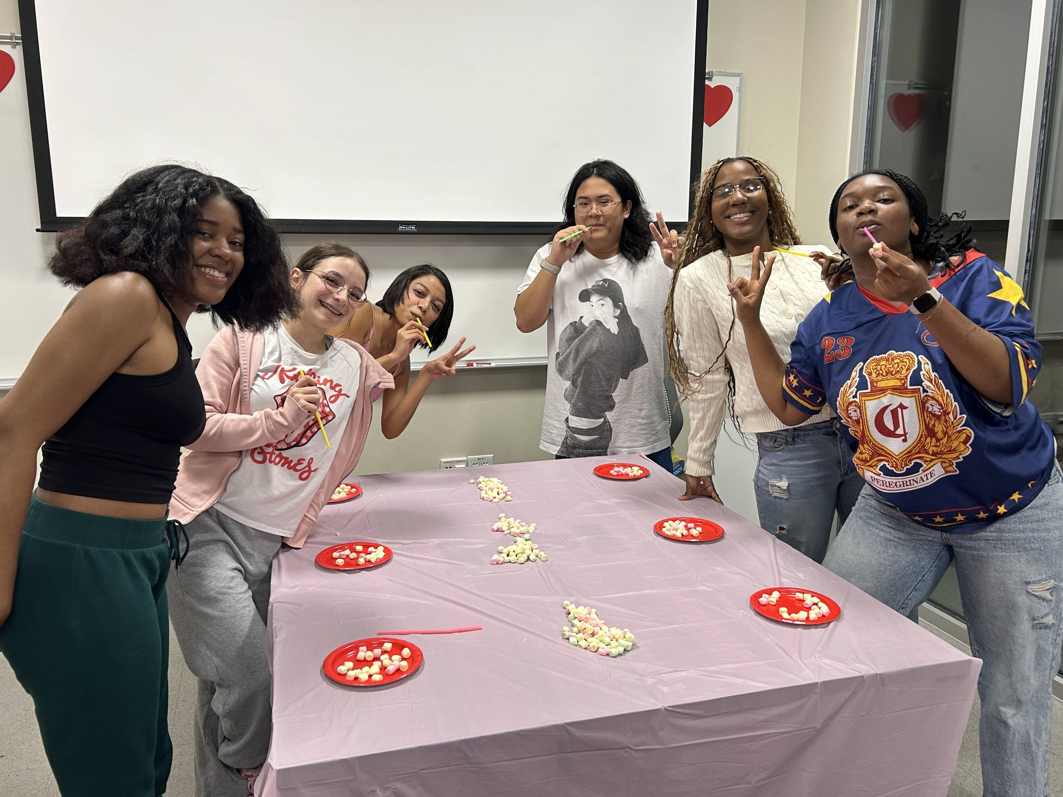 A group of people standing around a table