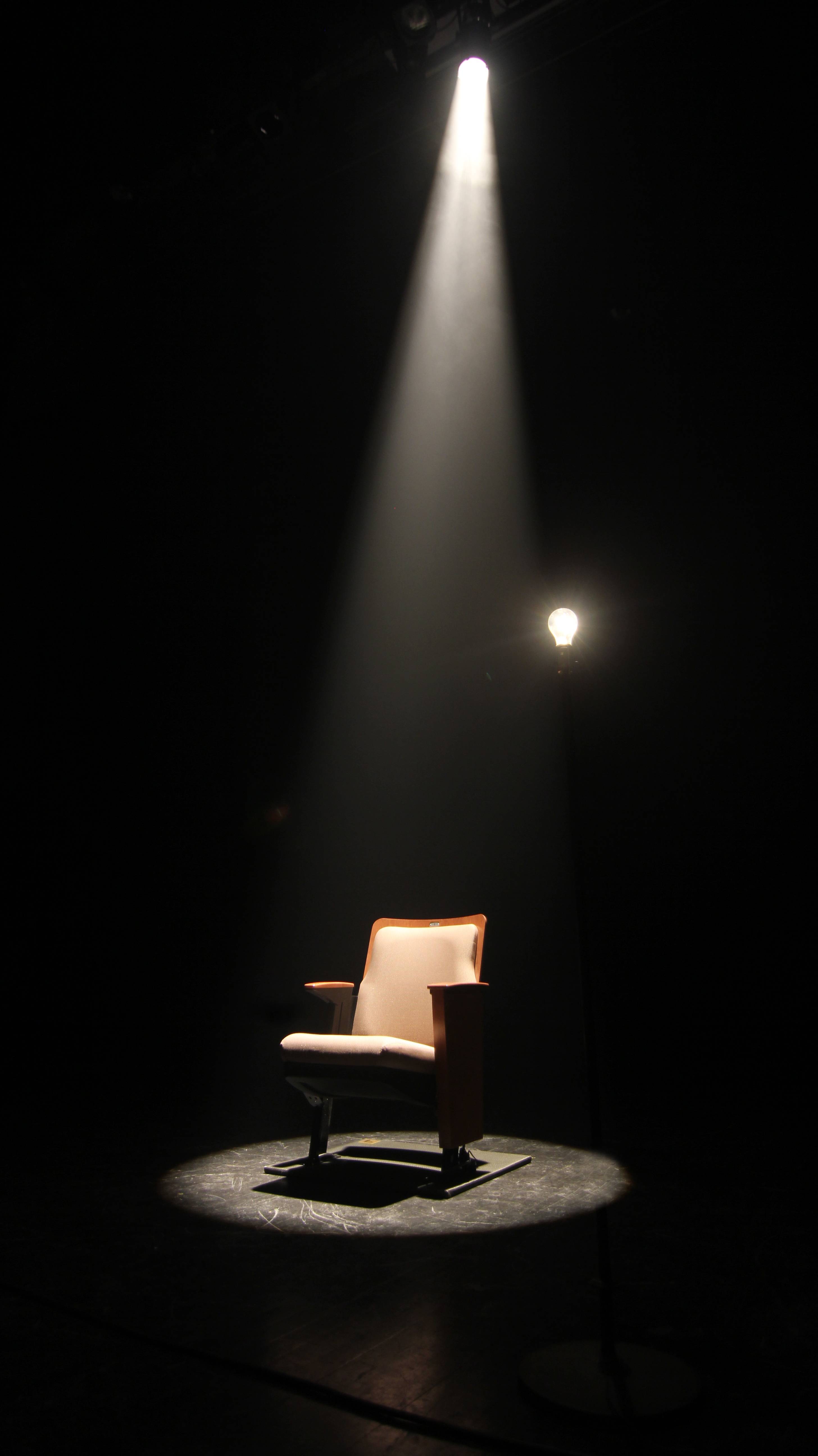 A photo of a light shining on a seat in the performing arts center