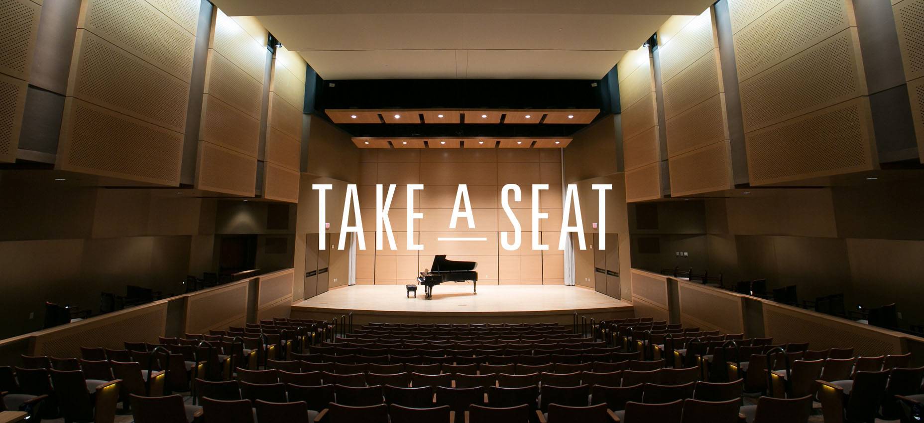 a piano on the stage of the performing arts center