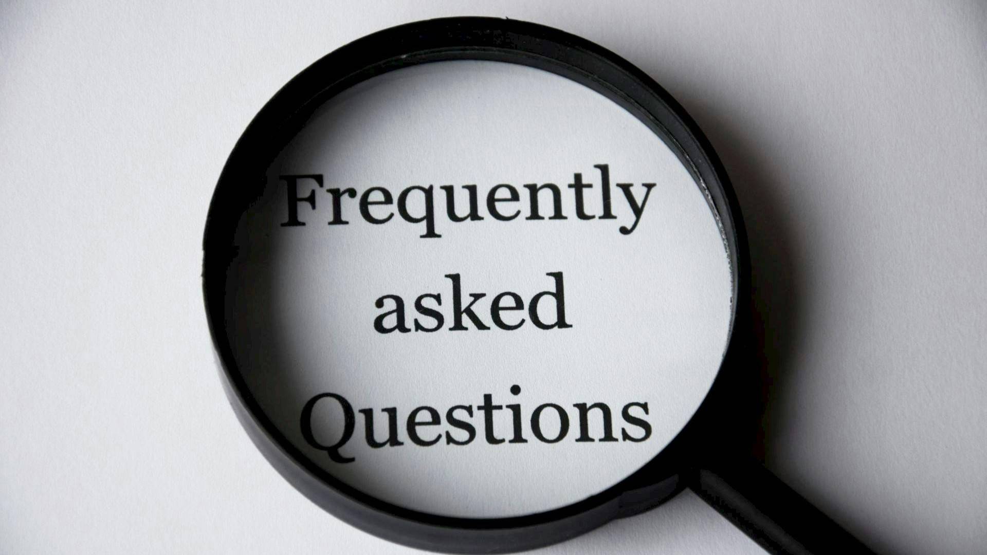 Magnifying glass over Frequently Asked Questions