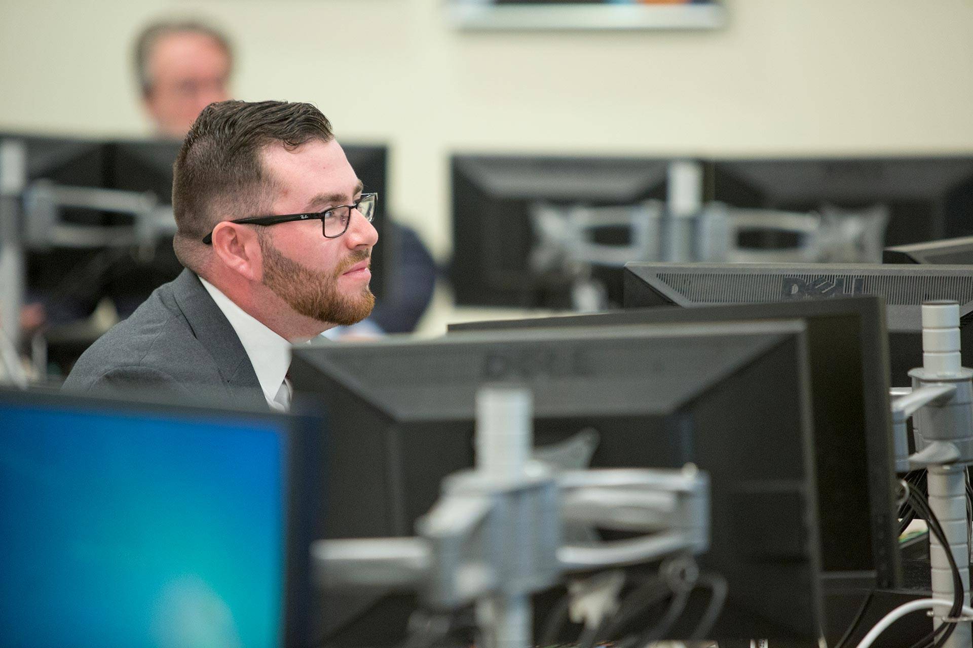 a man sits in a computer class