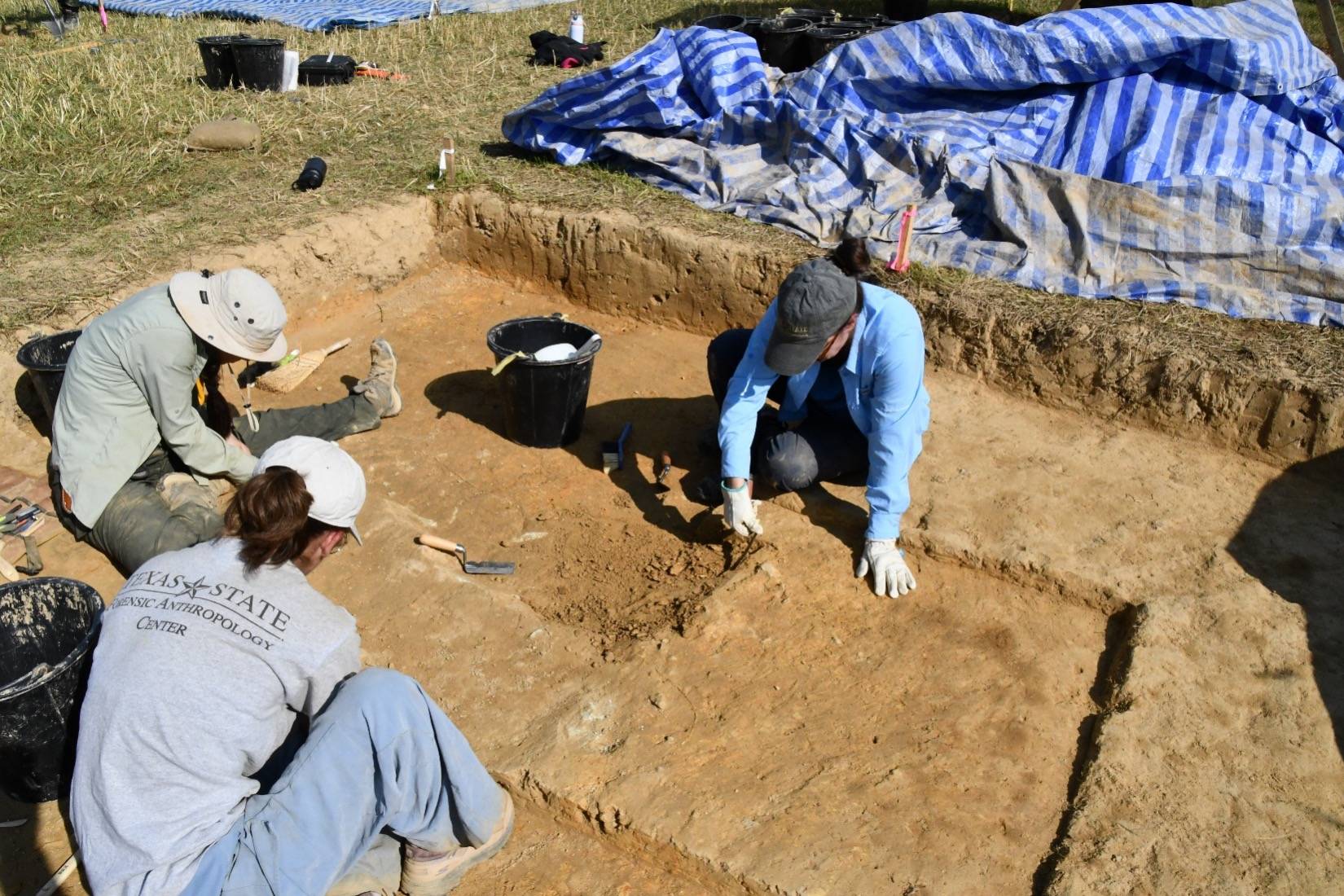 researchers digging in the ground
