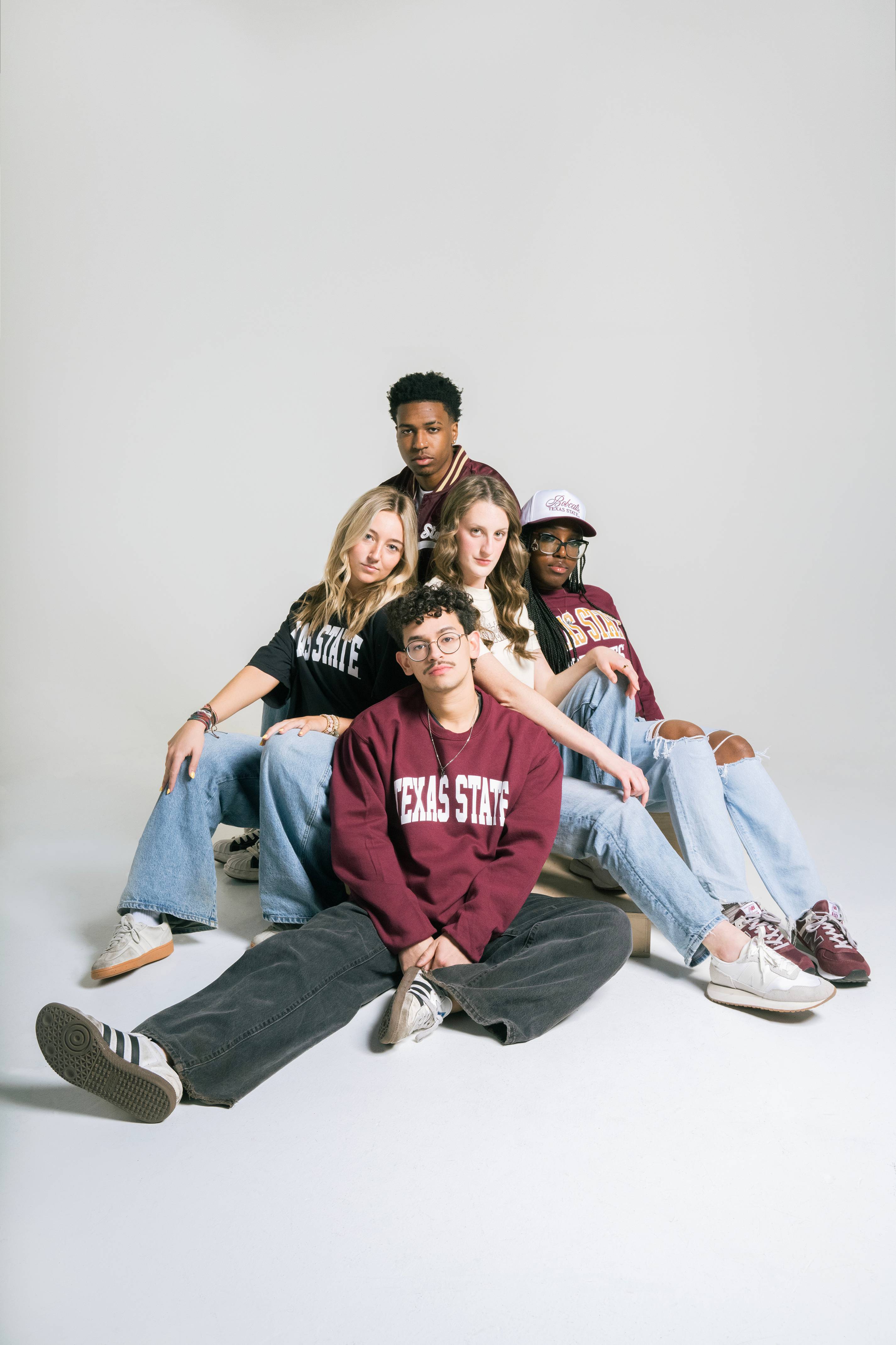 five students in texas state shirts shirt next to each other for posed photo