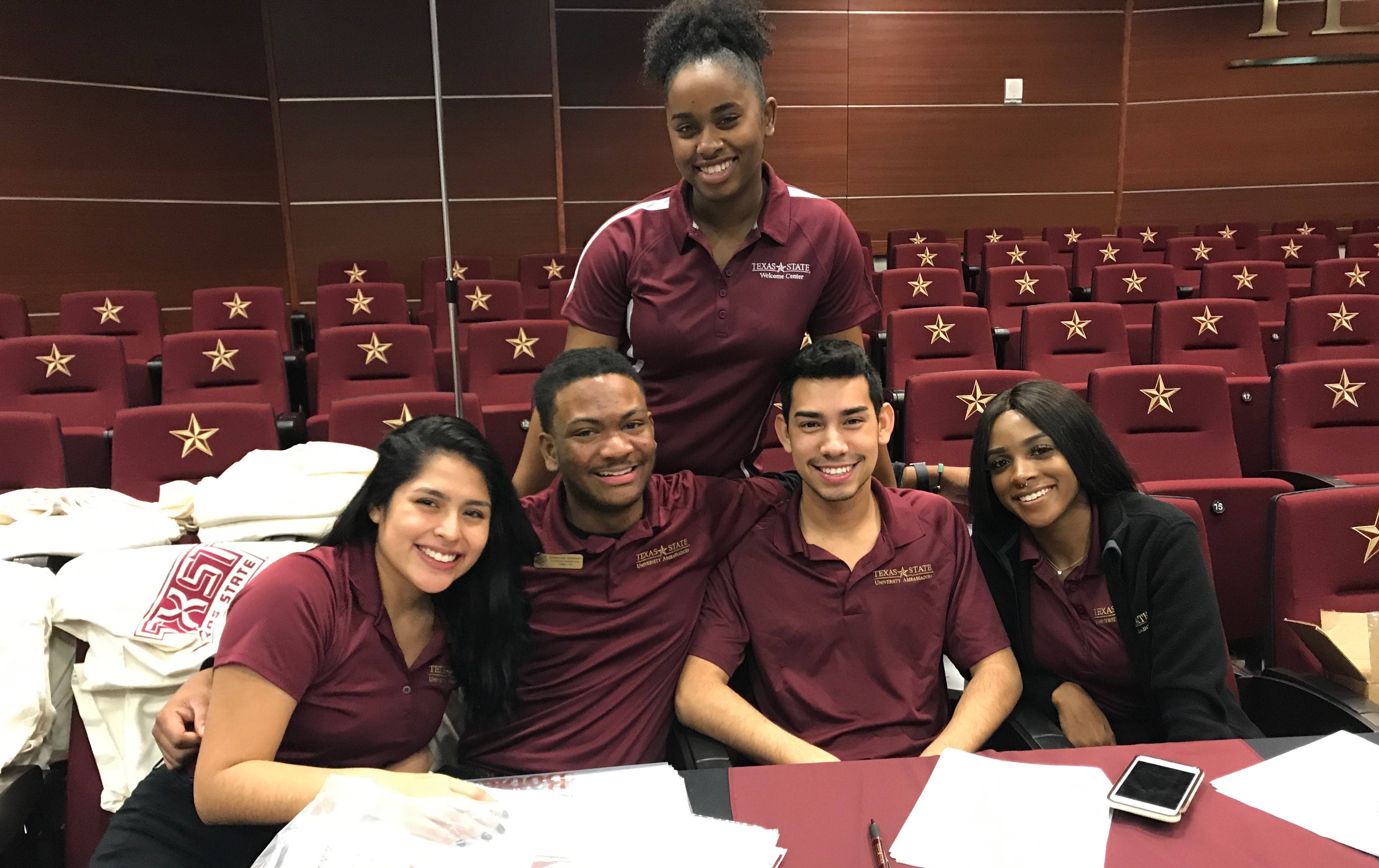 University Ambassadors smiling together in a teaching theater.