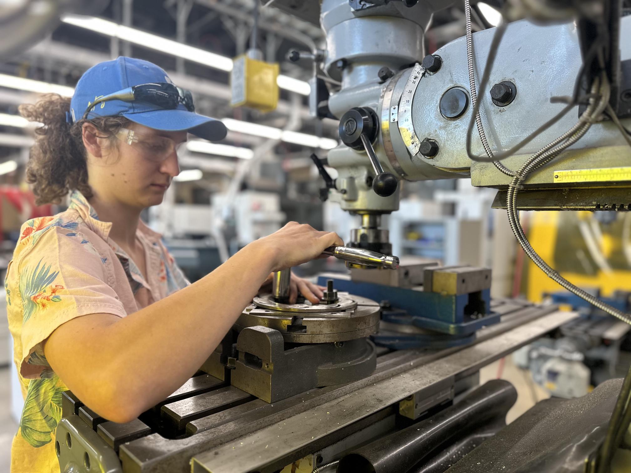 Student working on a manual mill