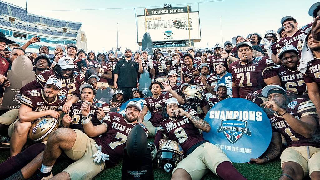 The TXST Bobcat Football team celebrate on the field after their bowl game victory.