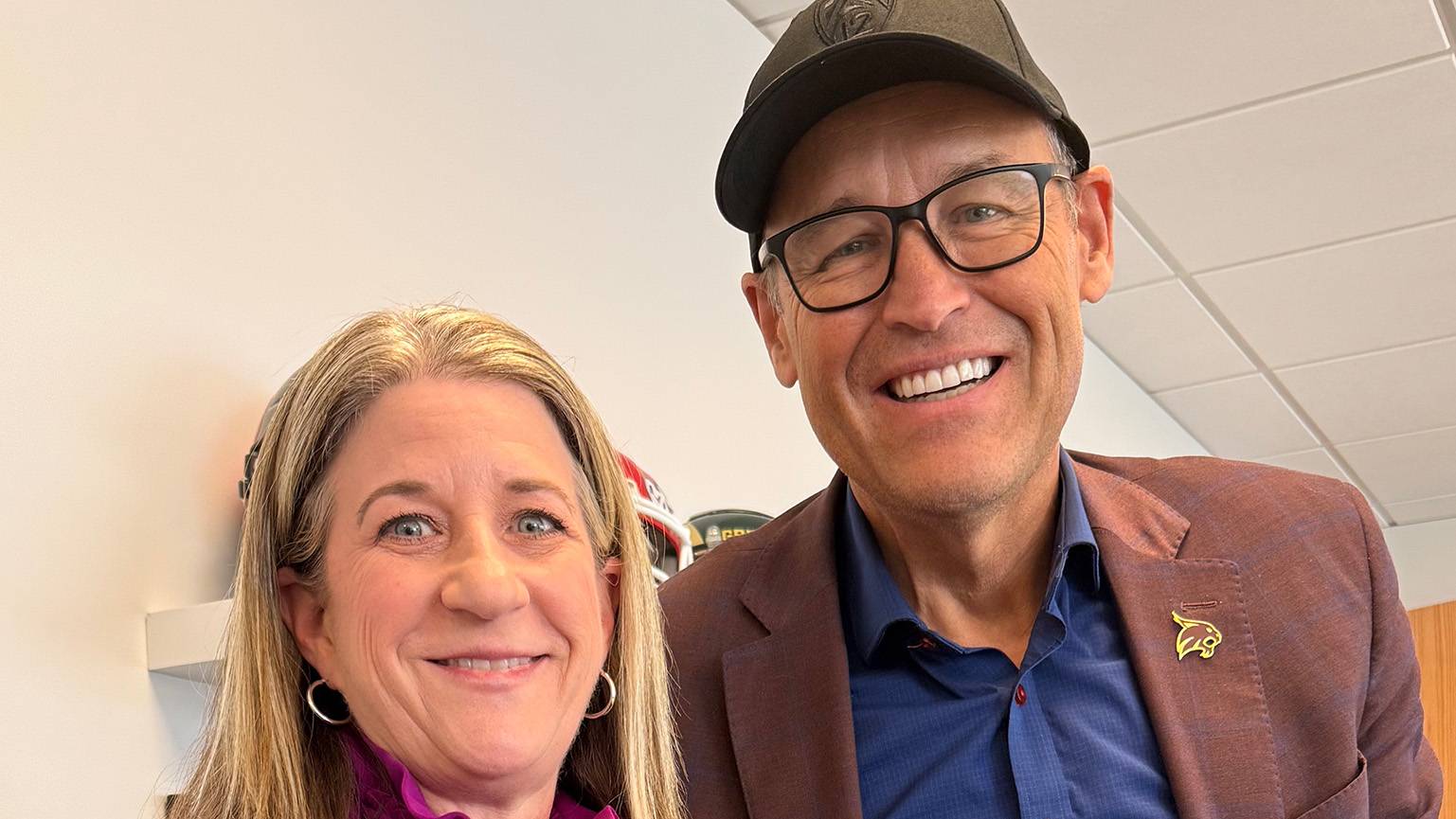 Pac-12 Commissioner Teresa Gould (left) poses for a photo with President Kelly Damphousse.