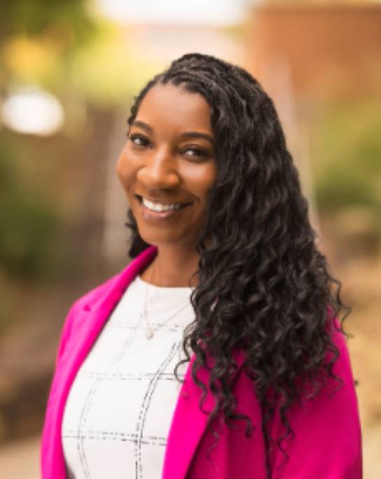 picture of a woman smiling with a blurred background