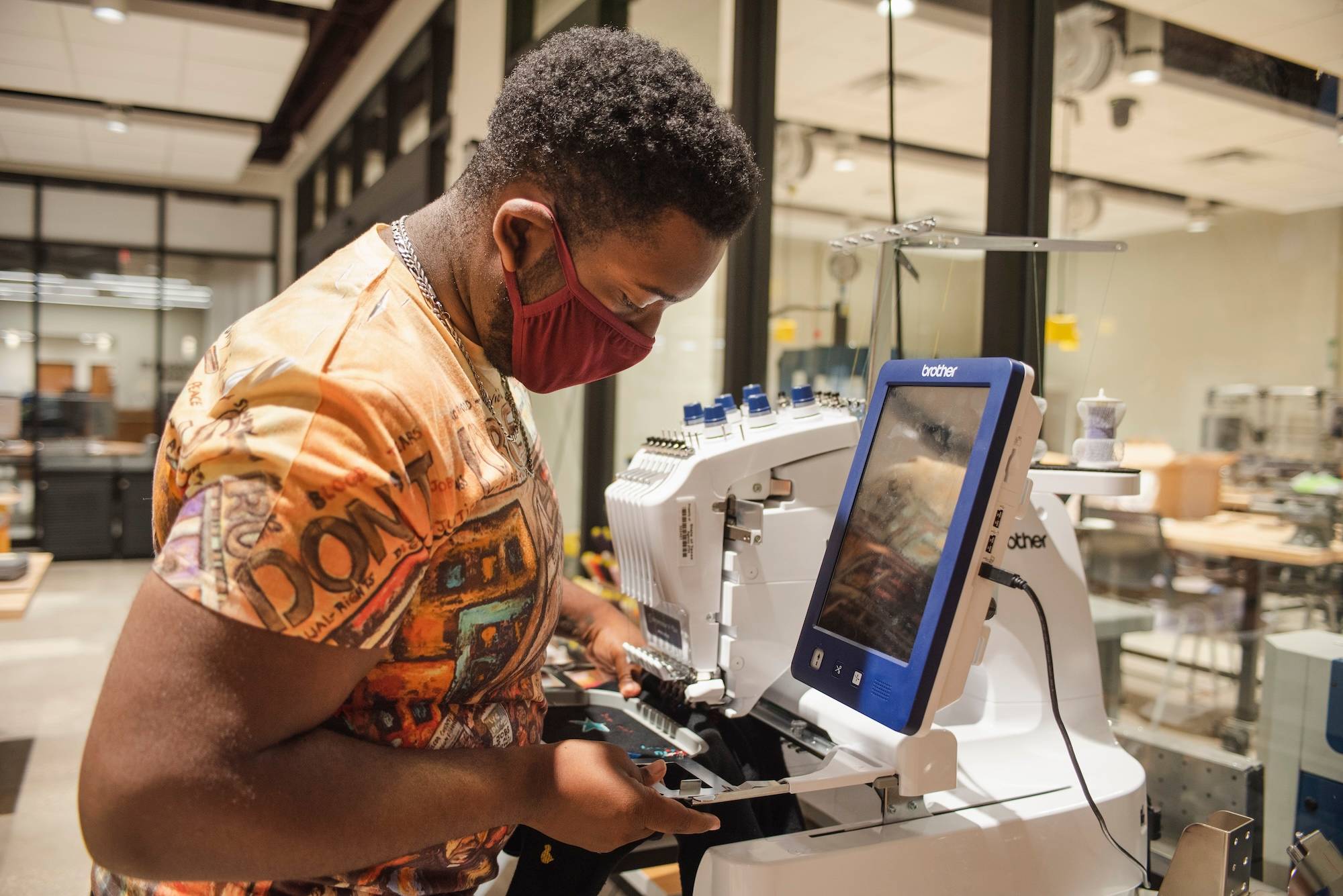 Texas State student using machine in Alkek One
