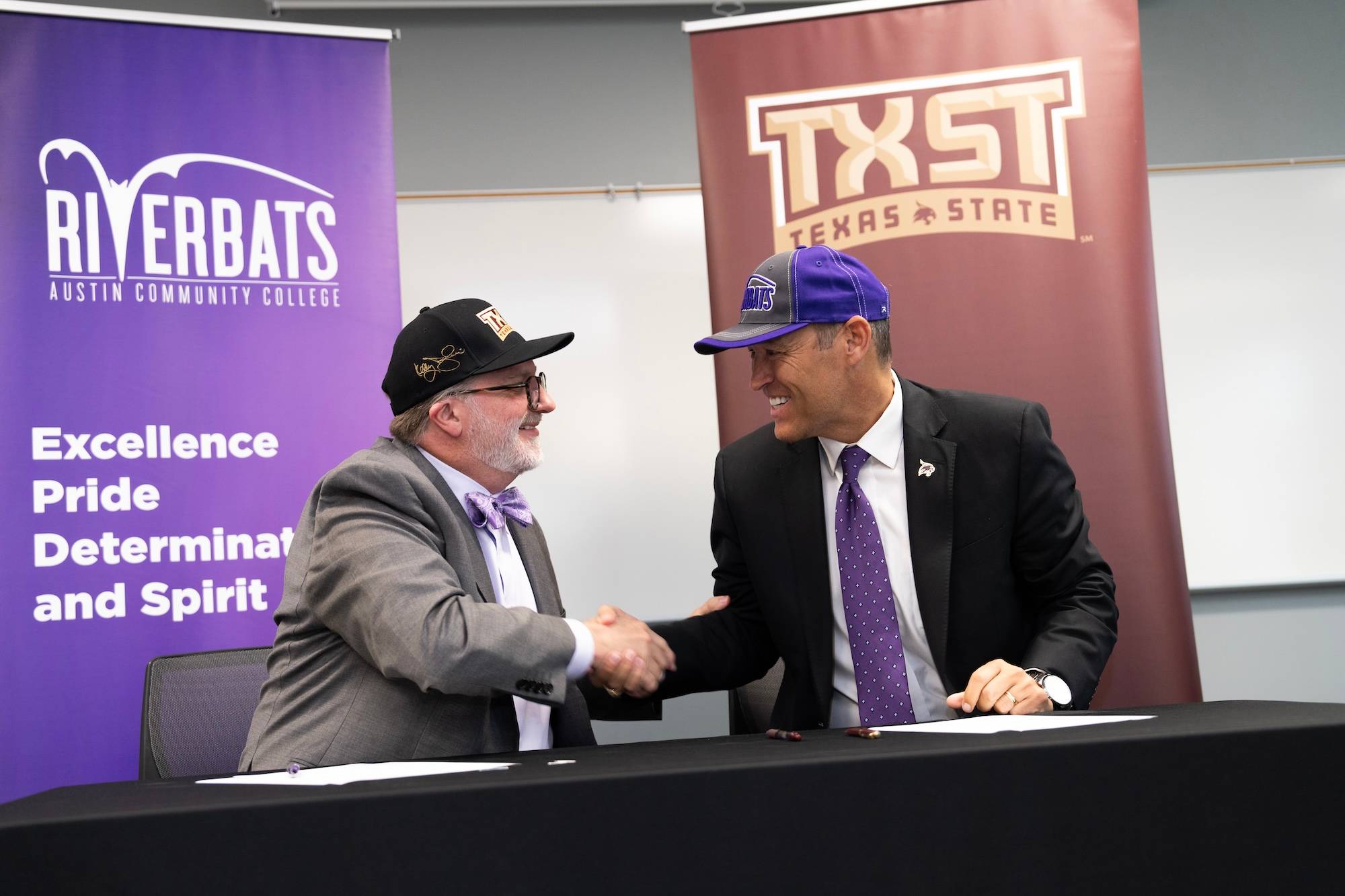Austin Community College chancellor and President Kelly Damphousse shaking hands