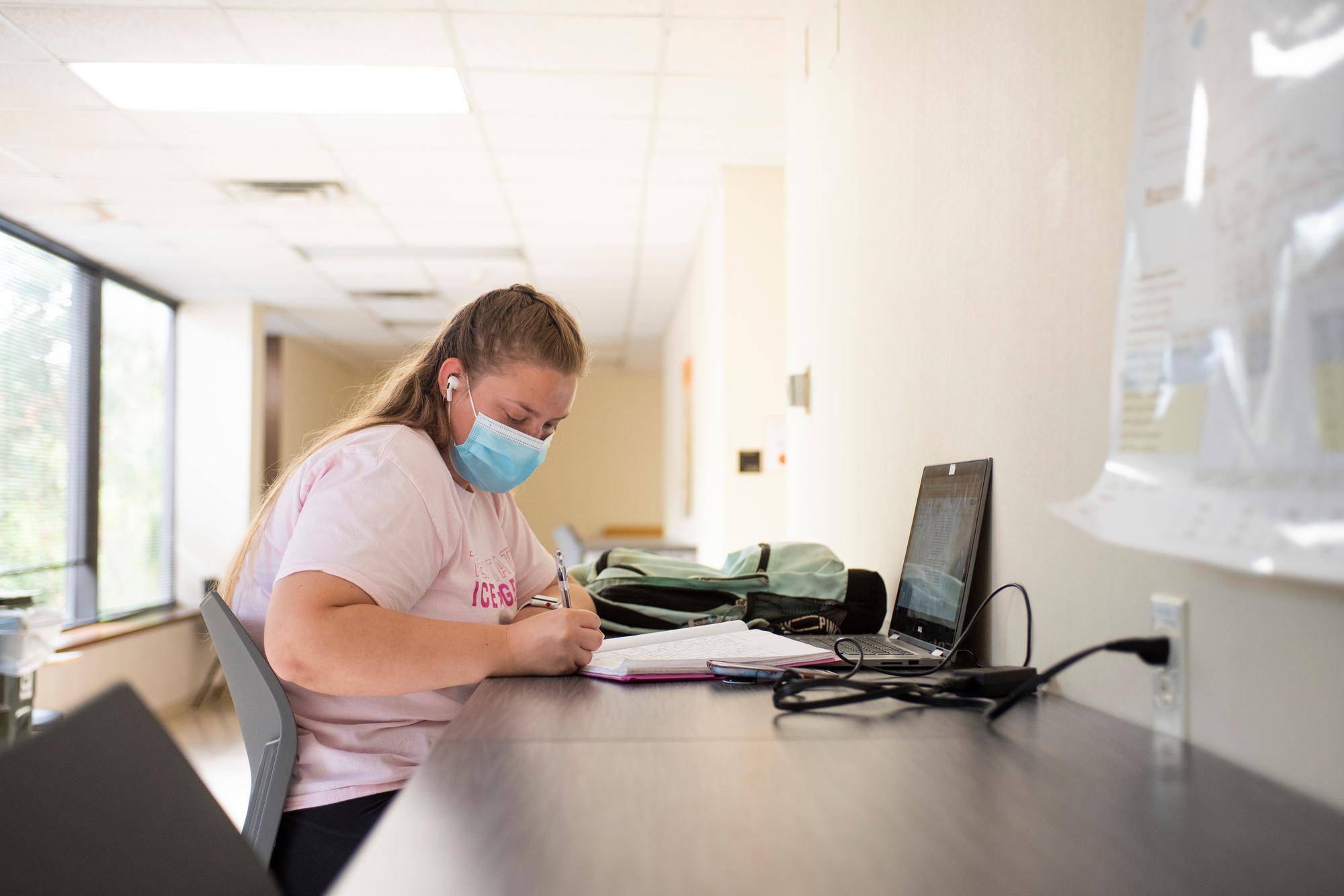 Student studying with a face mask on