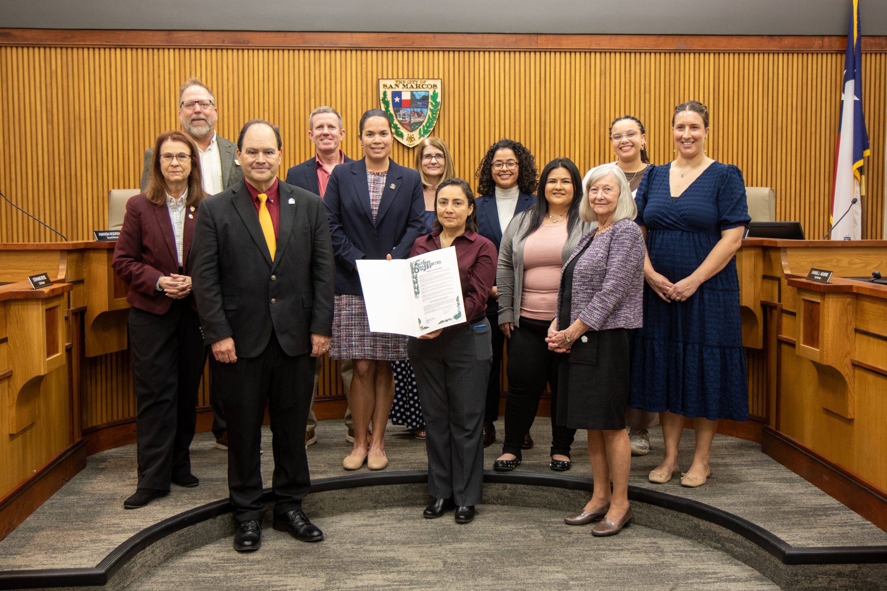 city officials pose for a group photo in a courthouse