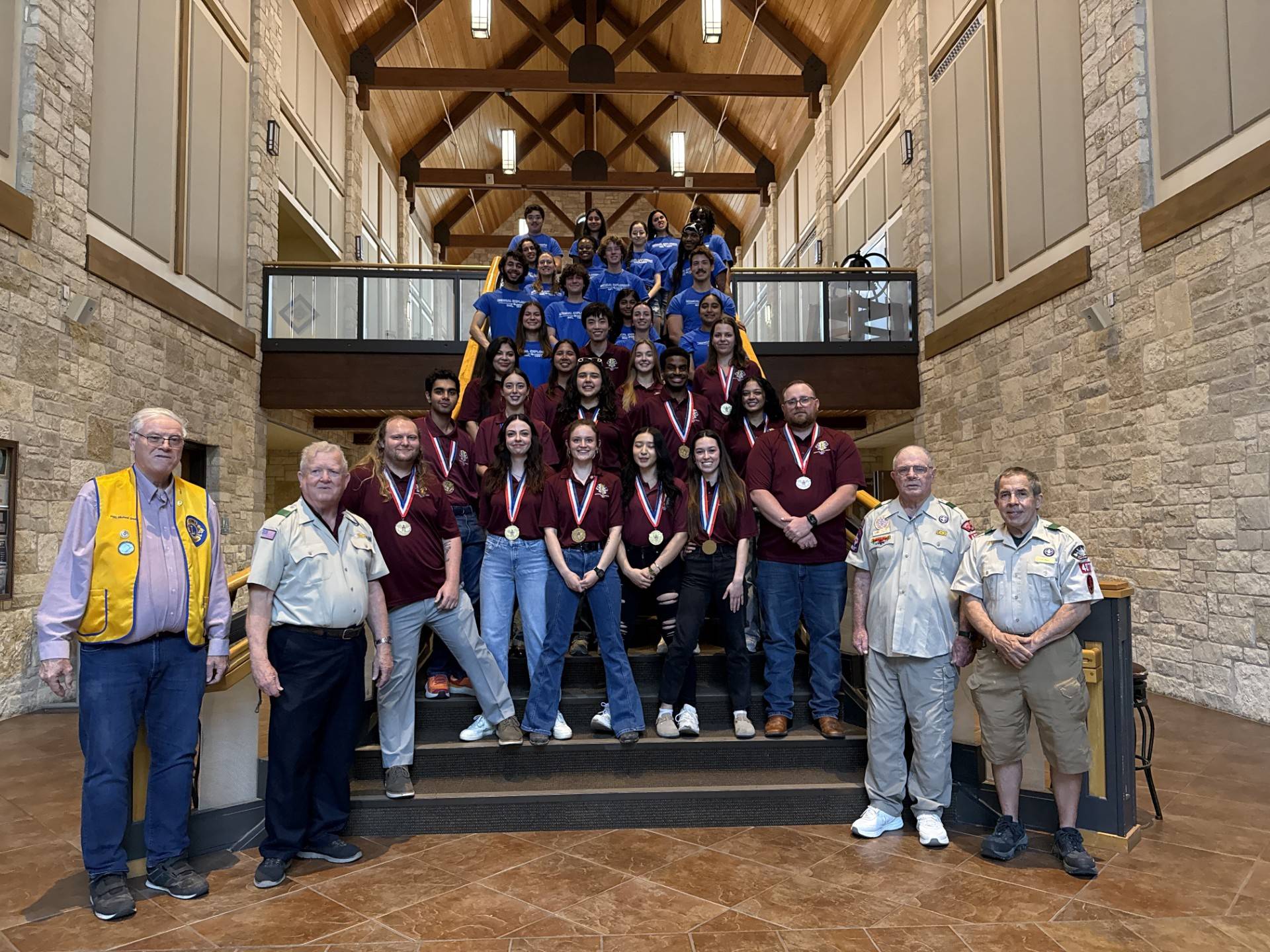 large group of medical explorer members posing for photo with lions club members