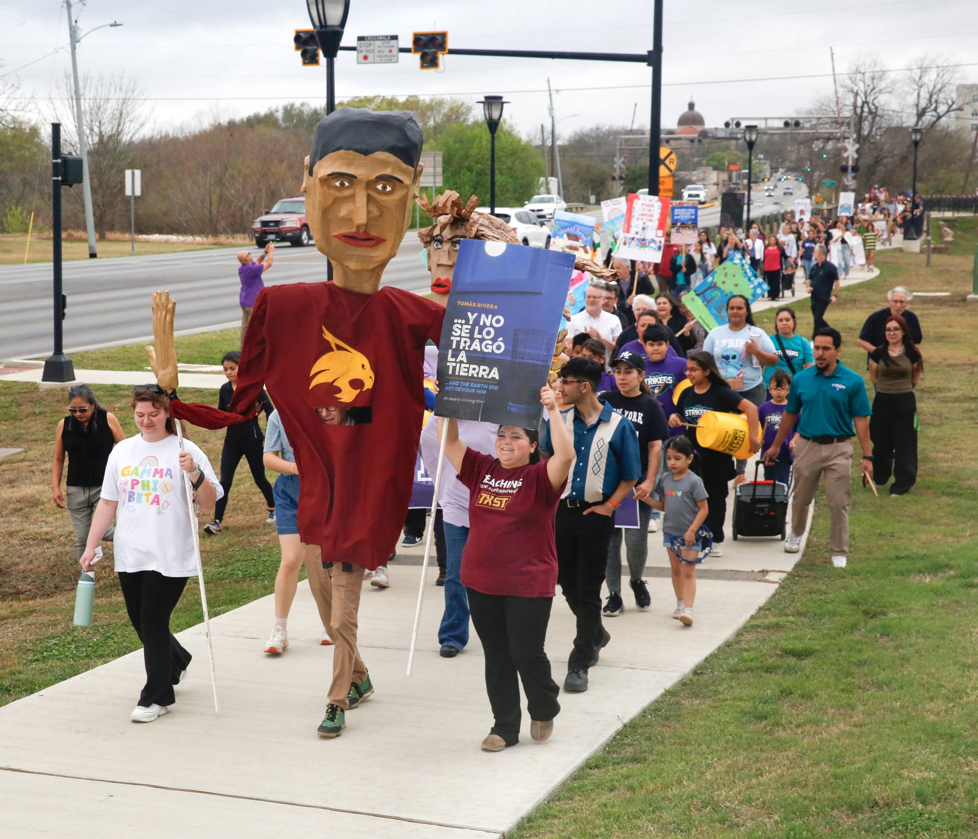 group of people marching on sidewalk