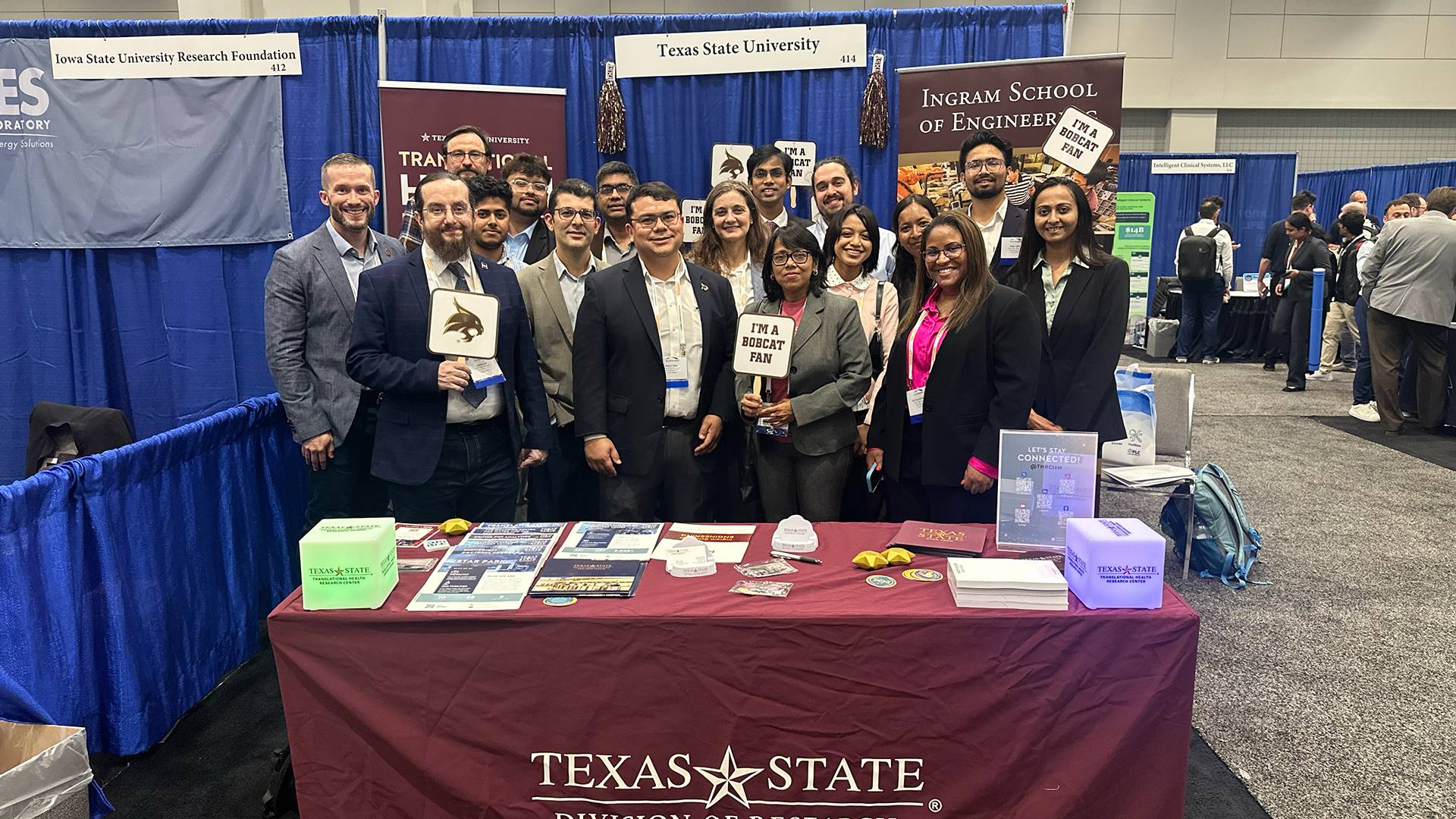 faculty members posing for a group photo at a conference