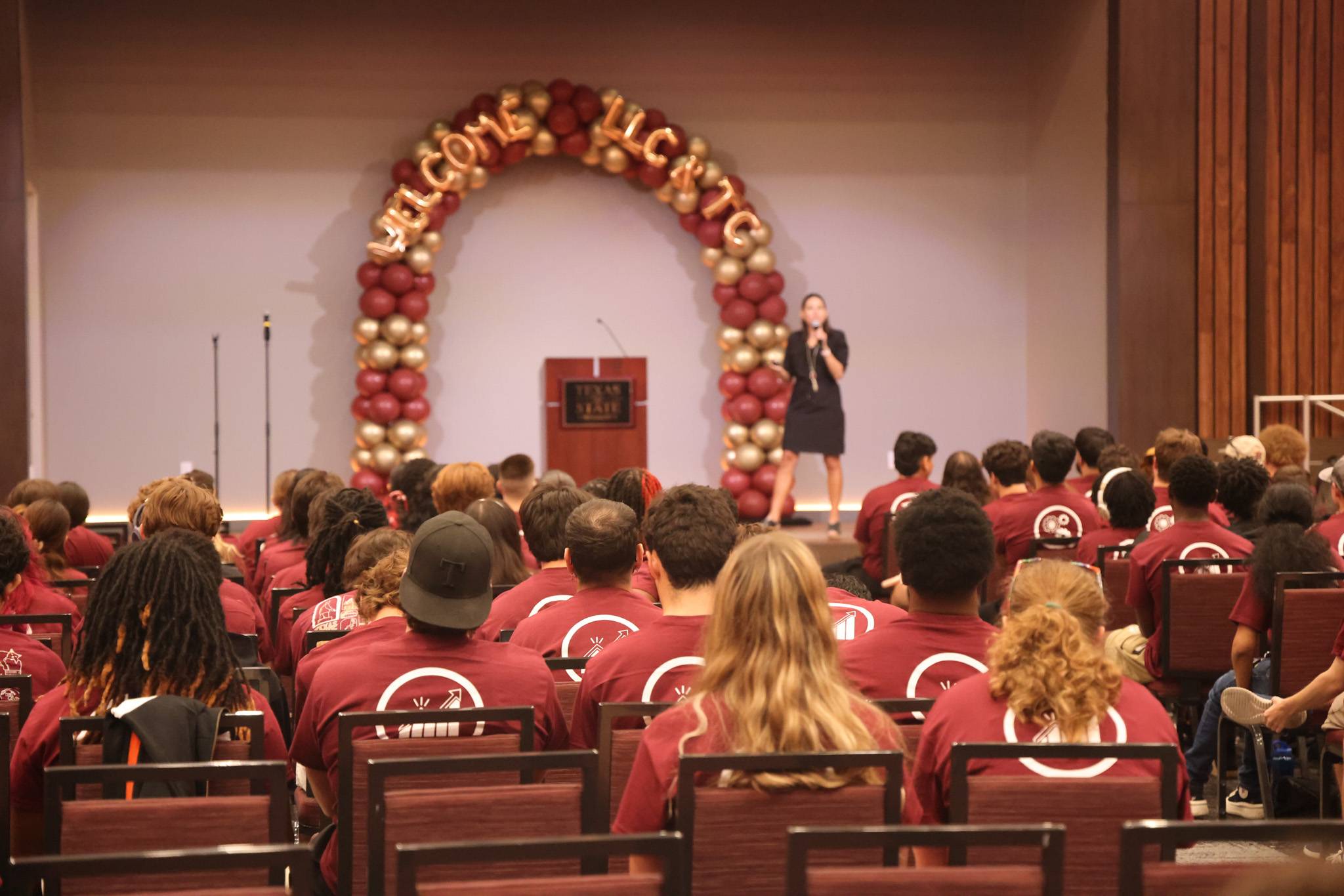 students in the LBJSC Grand ballroom watching a speaker present