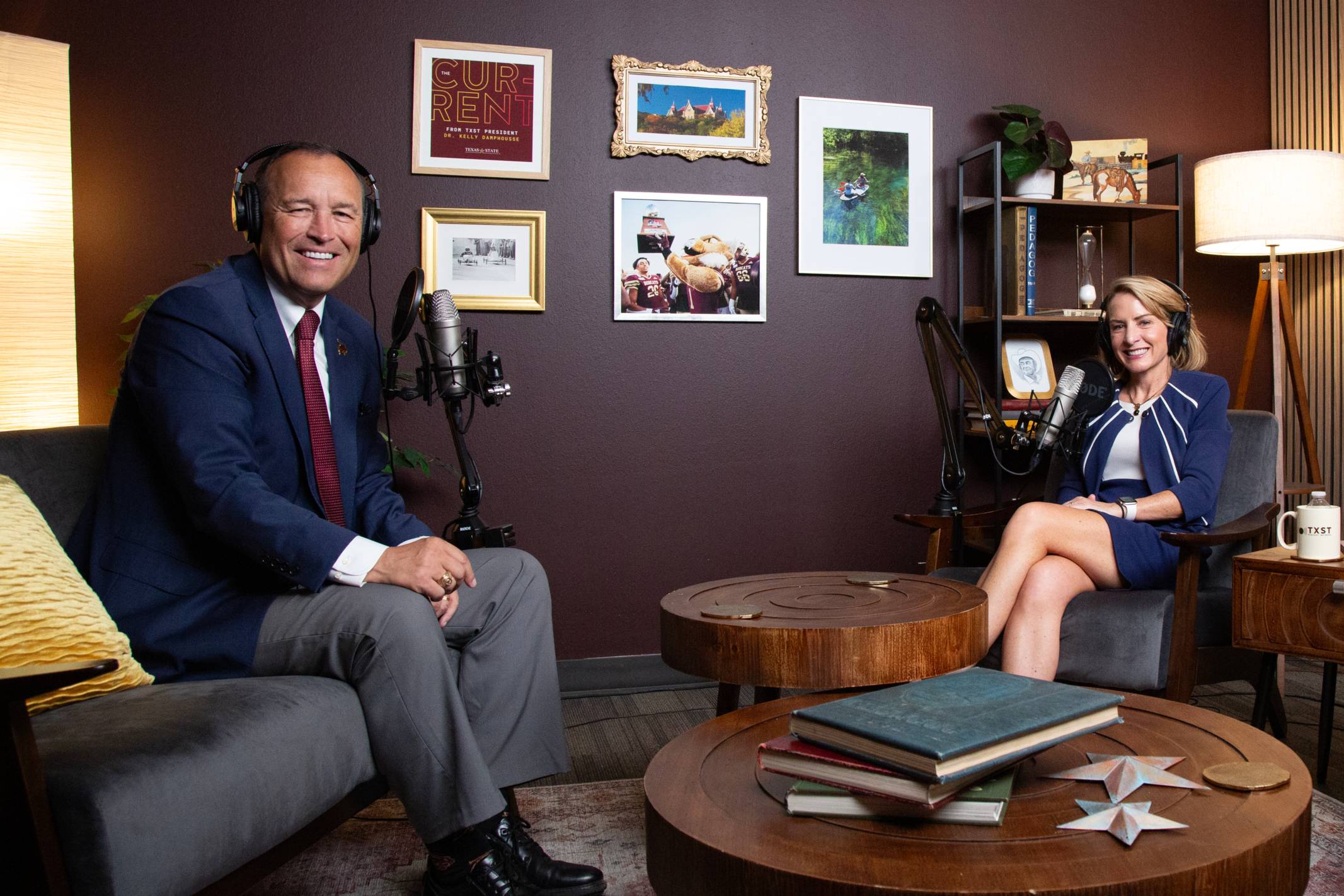 kelly damphousse and julie lessiter sitting on chairs in a dark, cozy podcast studio