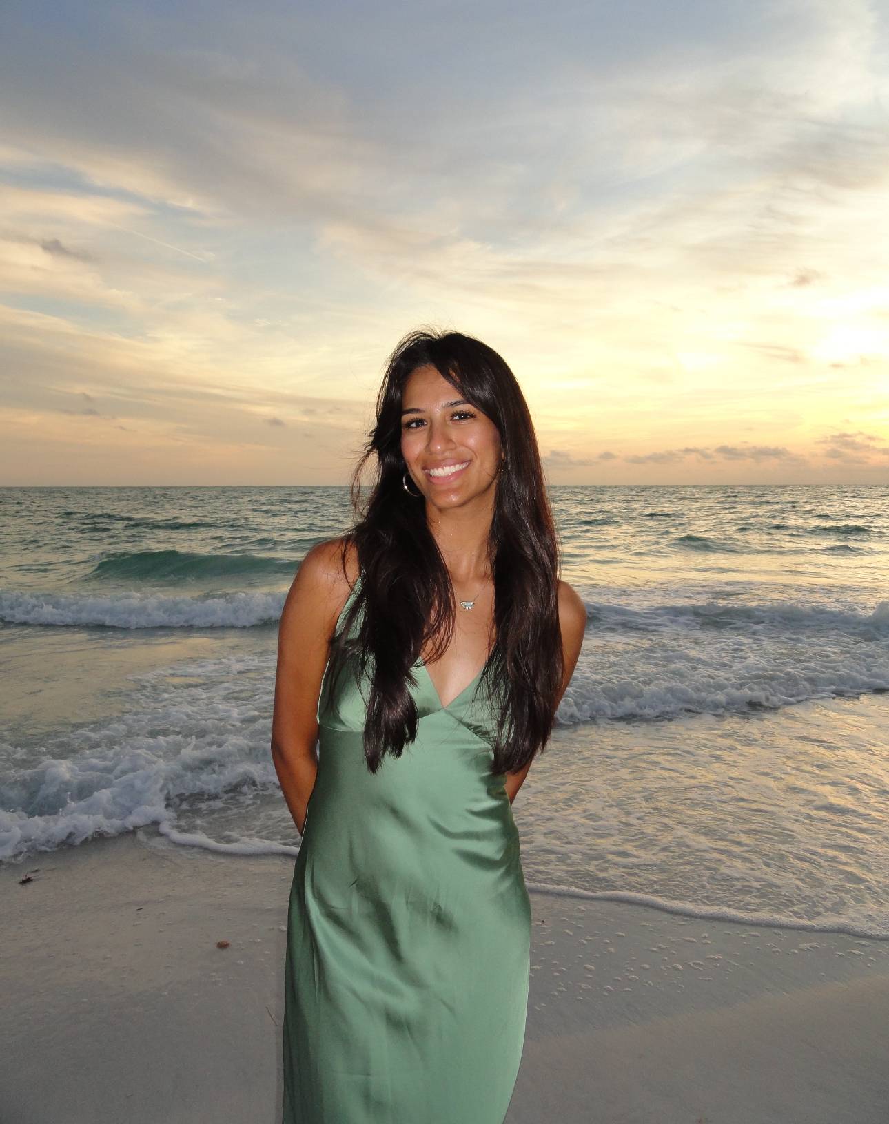 Ms. Lopez standing in front of a beach