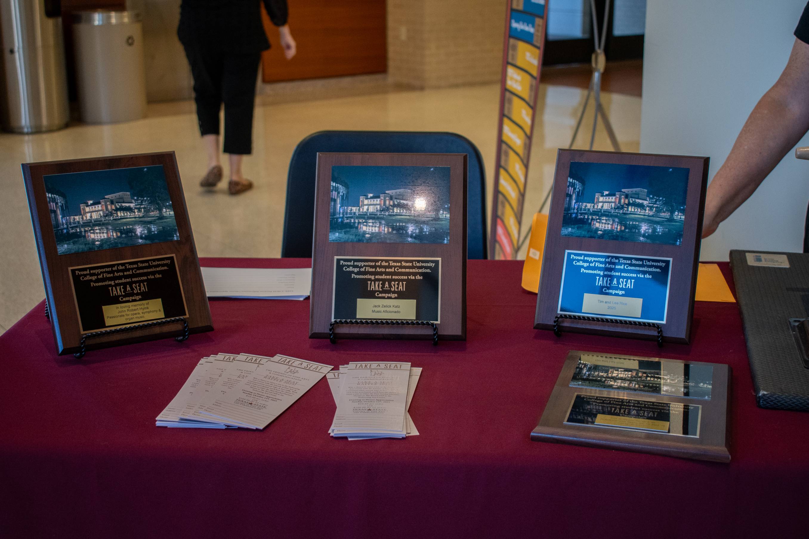3 plaques for those who have donated to the take a seat fund