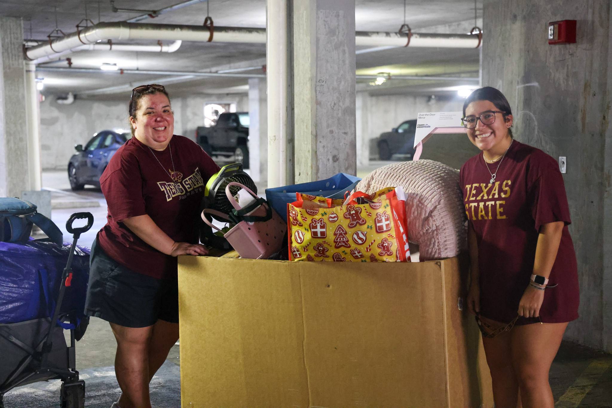 family pushing a move-in cart filled with items