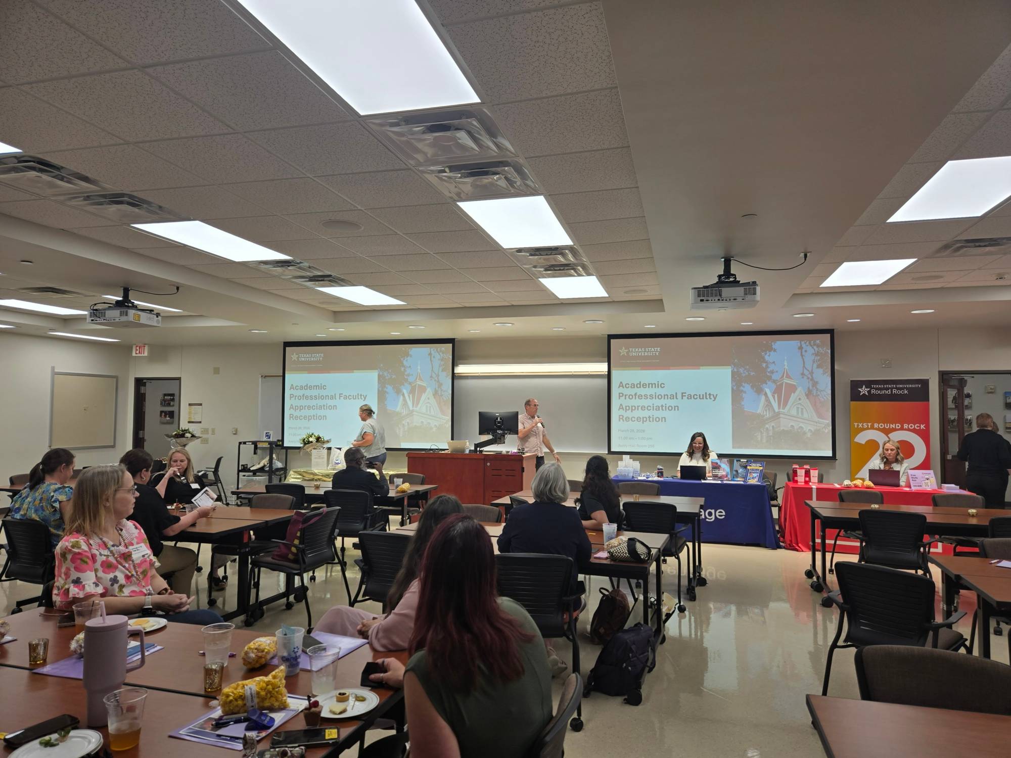 Faculty seated at tables during the Non-Tenure Line Faculty Luncheon, watching a presentation in a classroom at the Round Rock Campus.