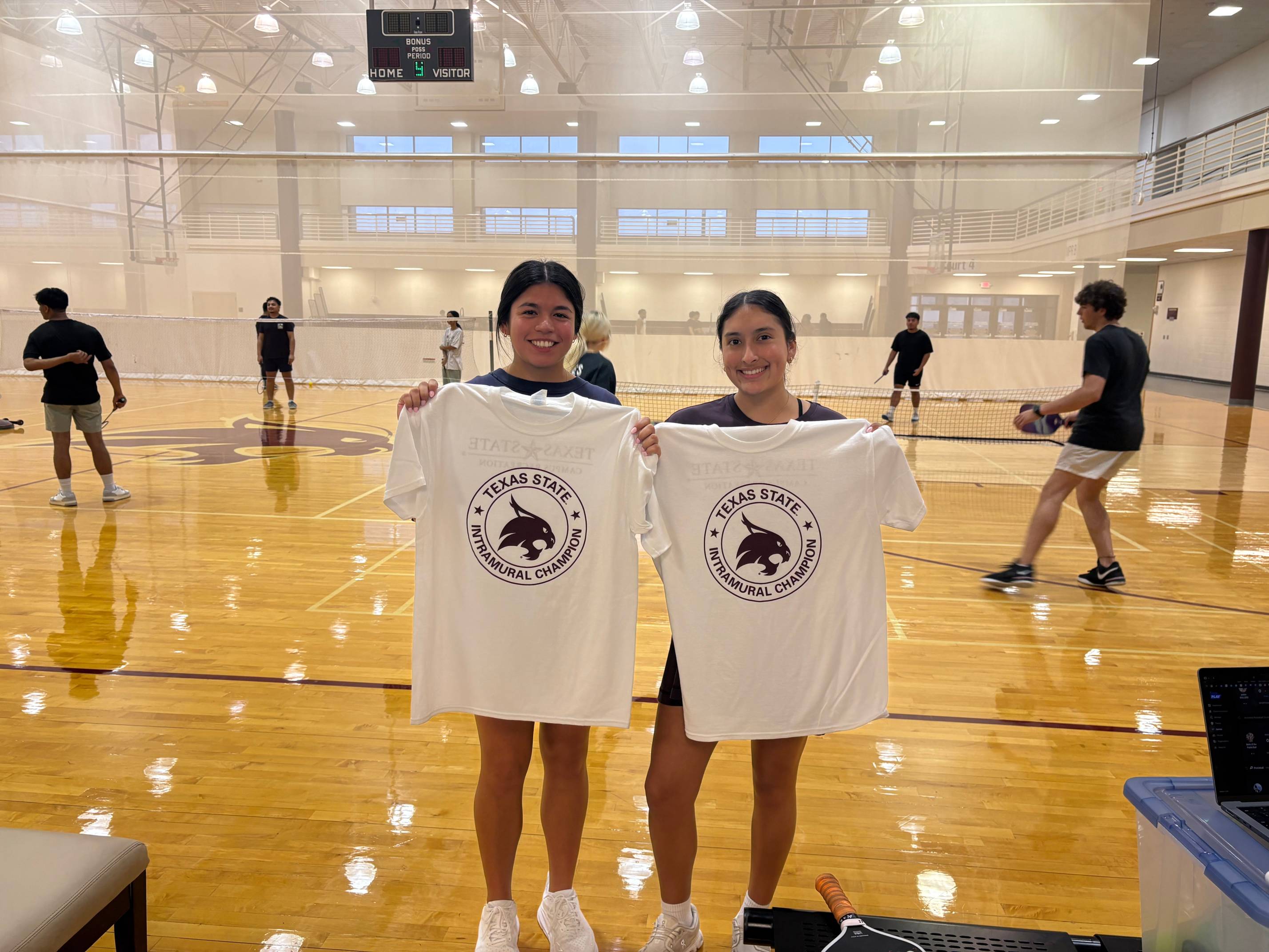 Intramurals champions from women's pickleball doubles league pose with shirt