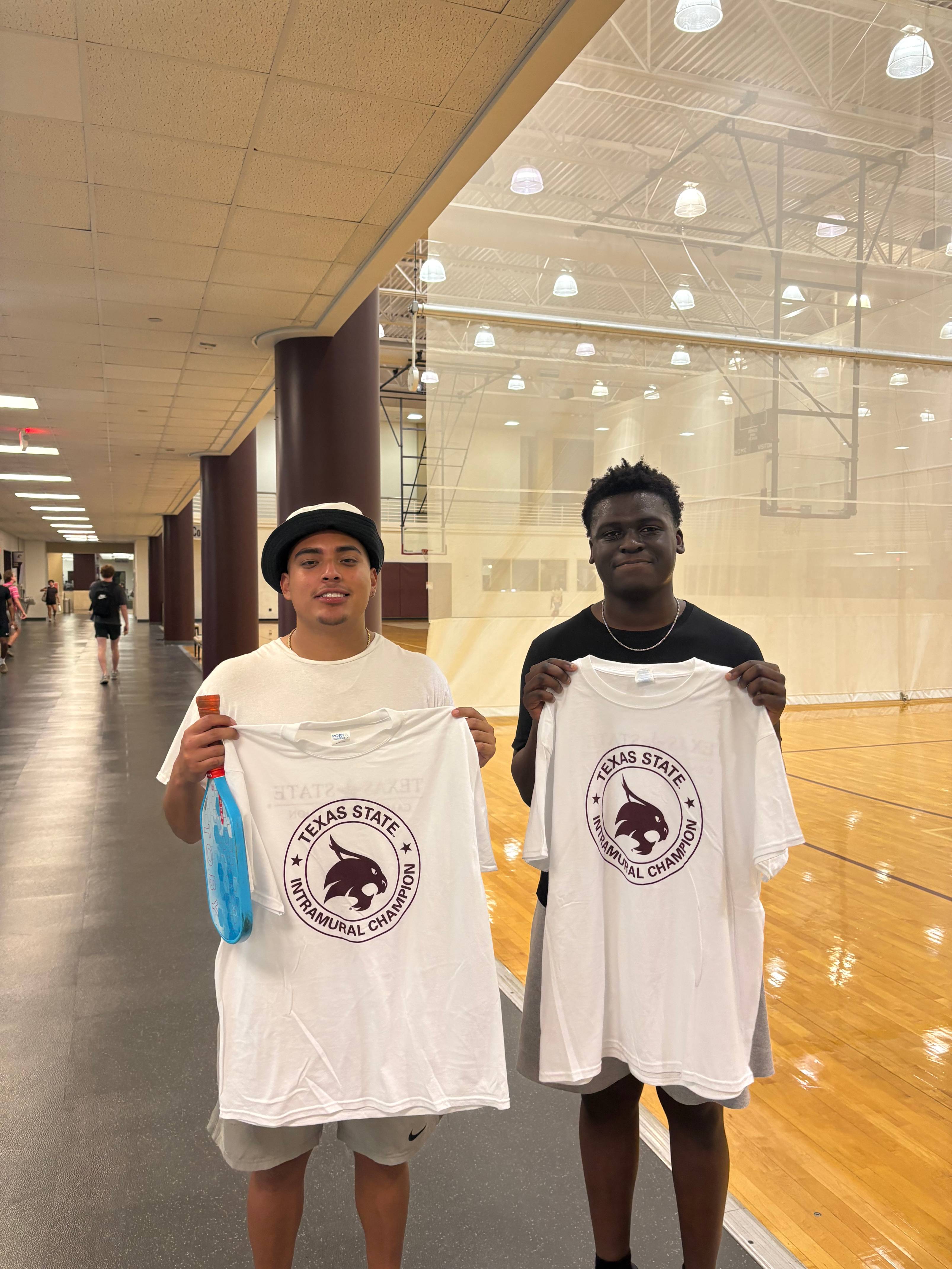 Intramurals champions from men's pickleball doubles league pose with shirt