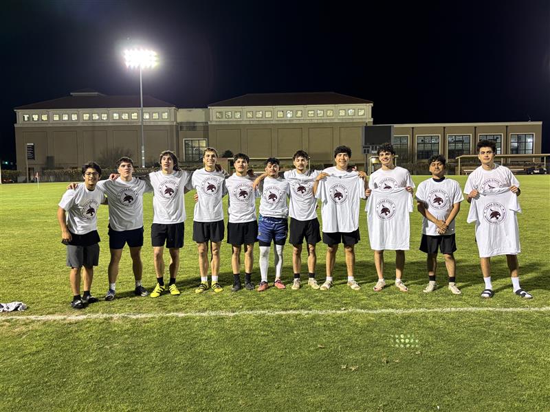 Intramurals champions from men's soccer league pose with shirt