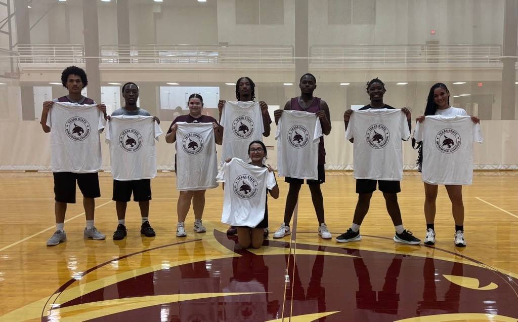 intramural champs pose with shirt after winning 