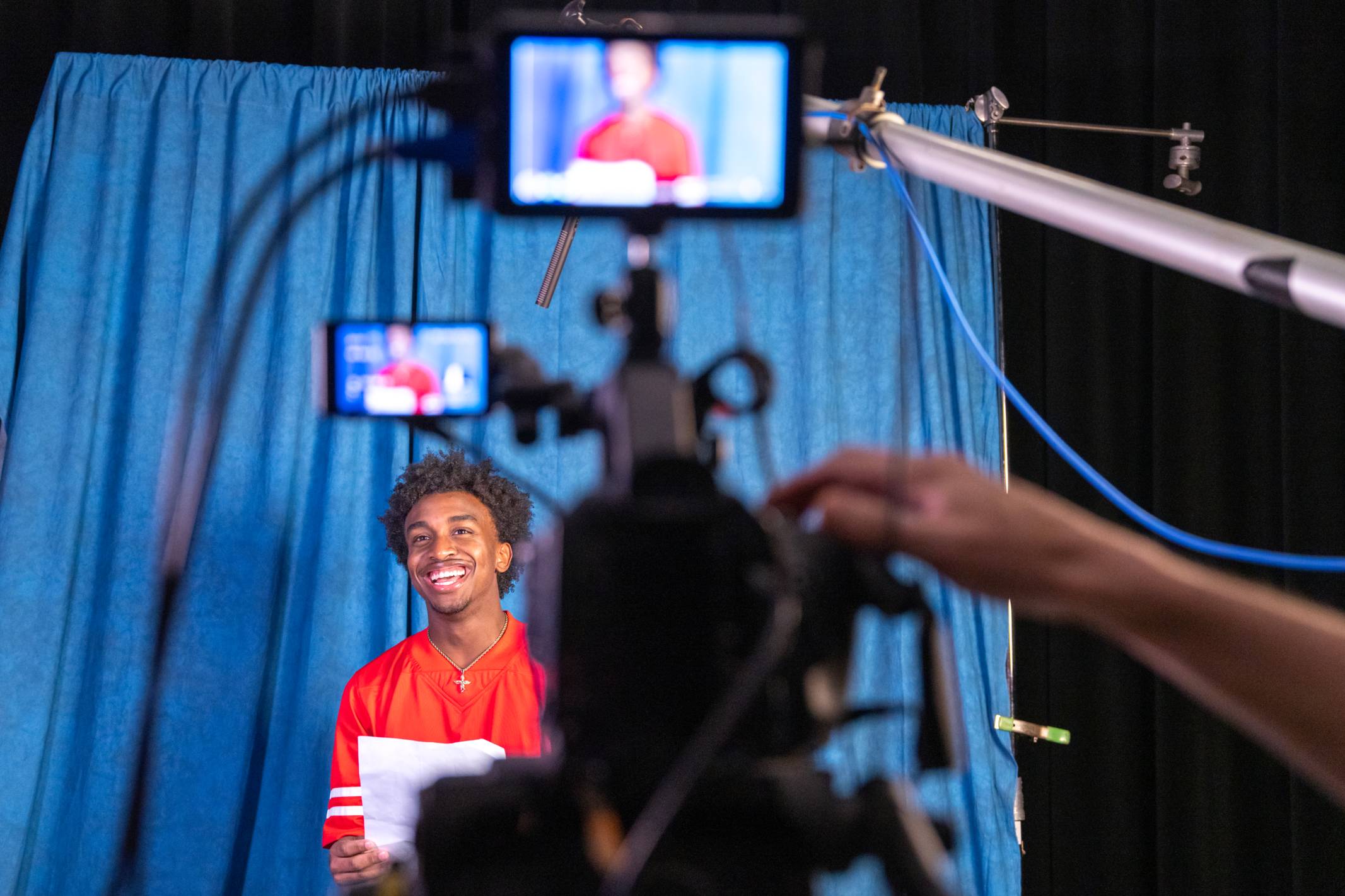 a boy acting in front of a camera on stage