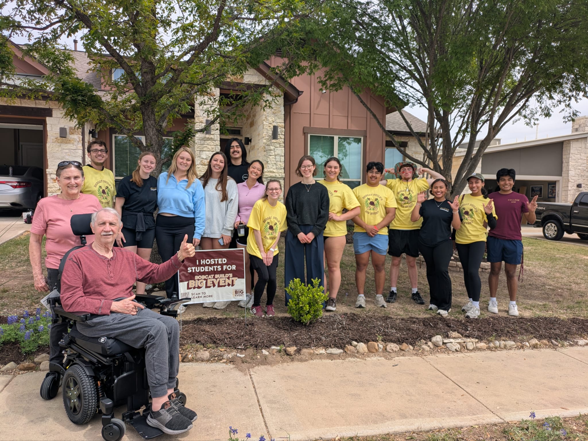 McCoy Ambassadors at a Bobcat Build site, standing in the front yard of a home with the homeowners