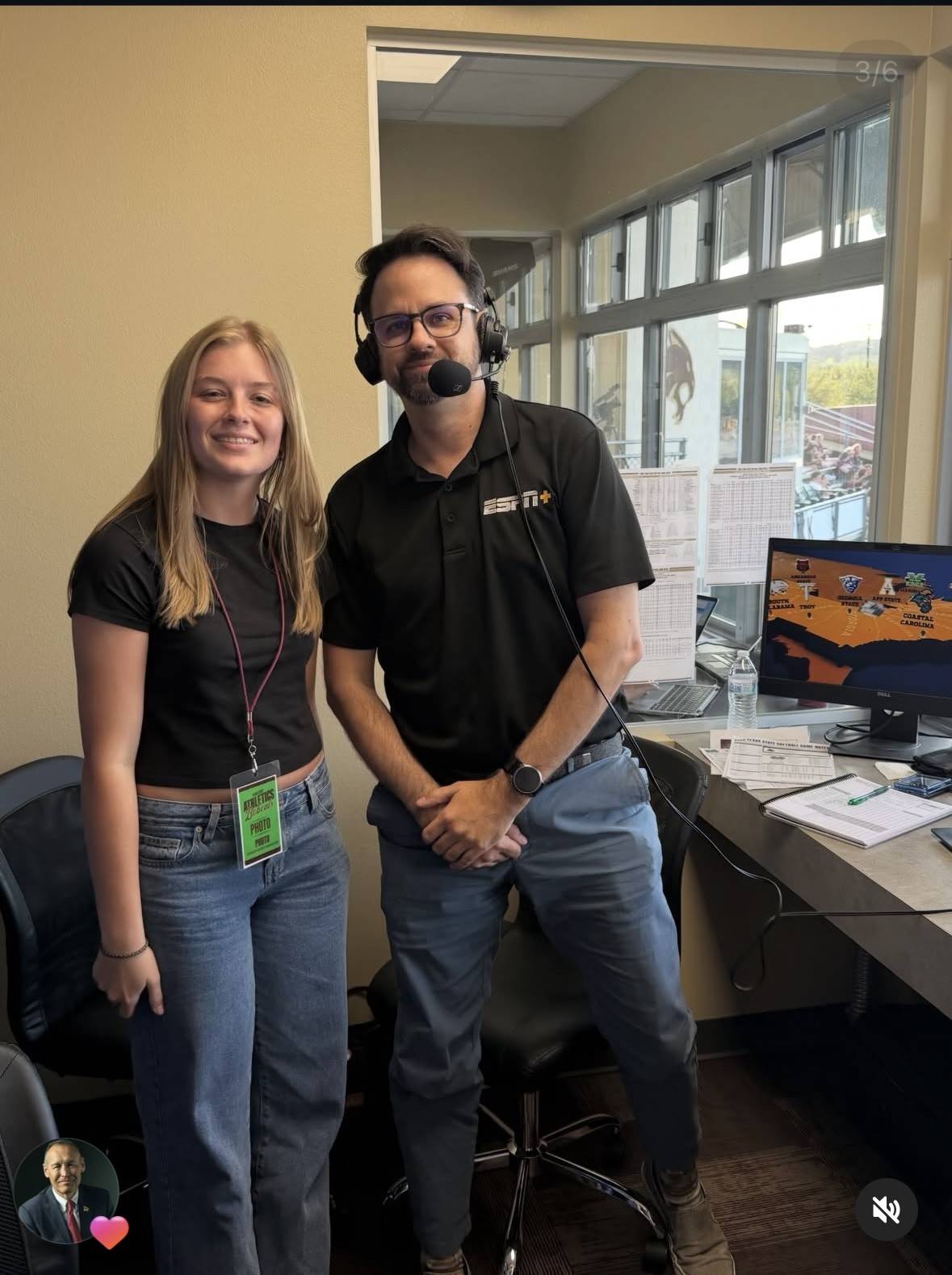 student standing in a press box with an ESPN official announcer