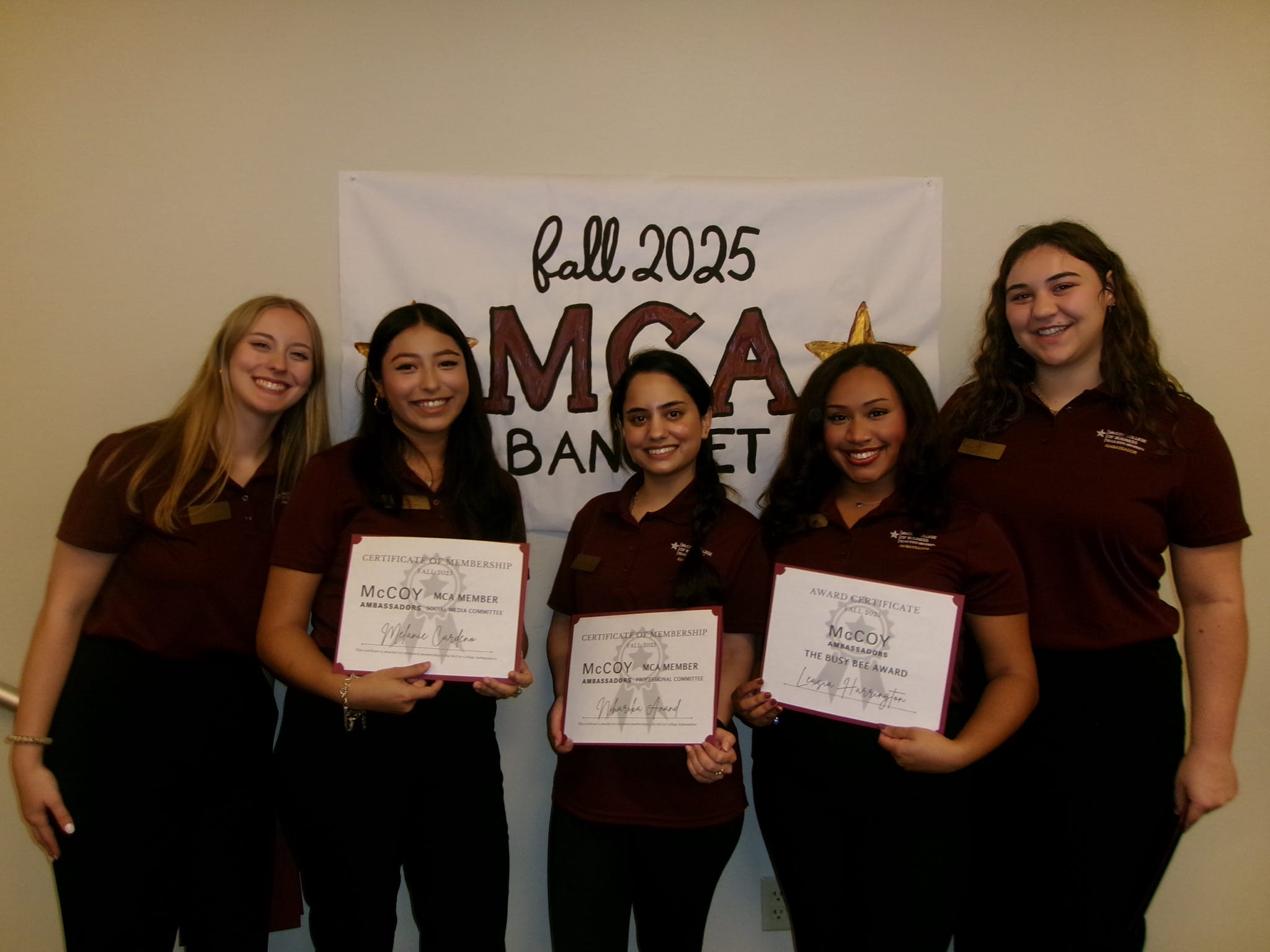 Five McCoy Ambassadors, standing with certificates at the Ambassadors Banquet