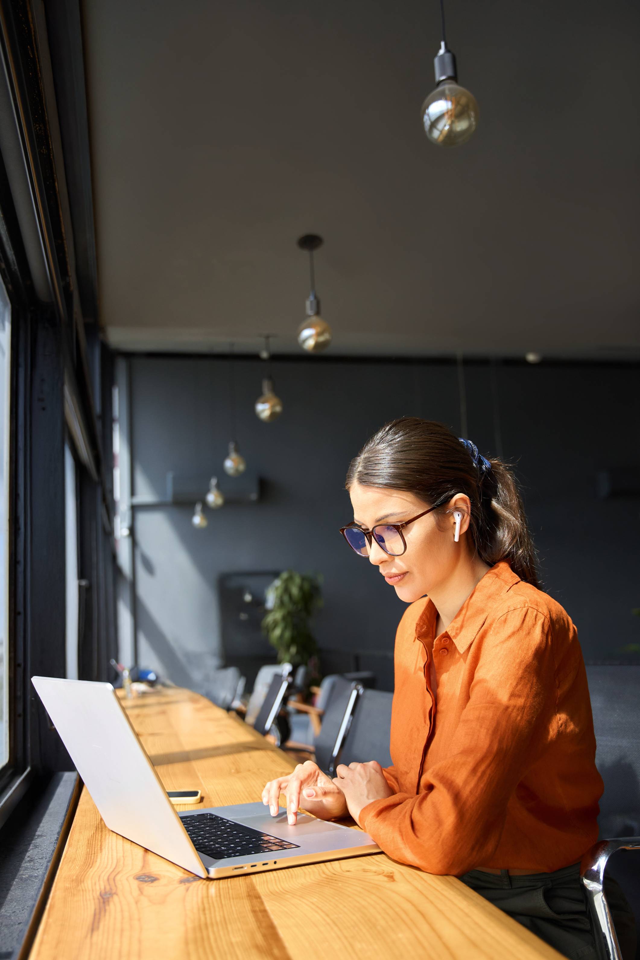 a woman works on a laptop