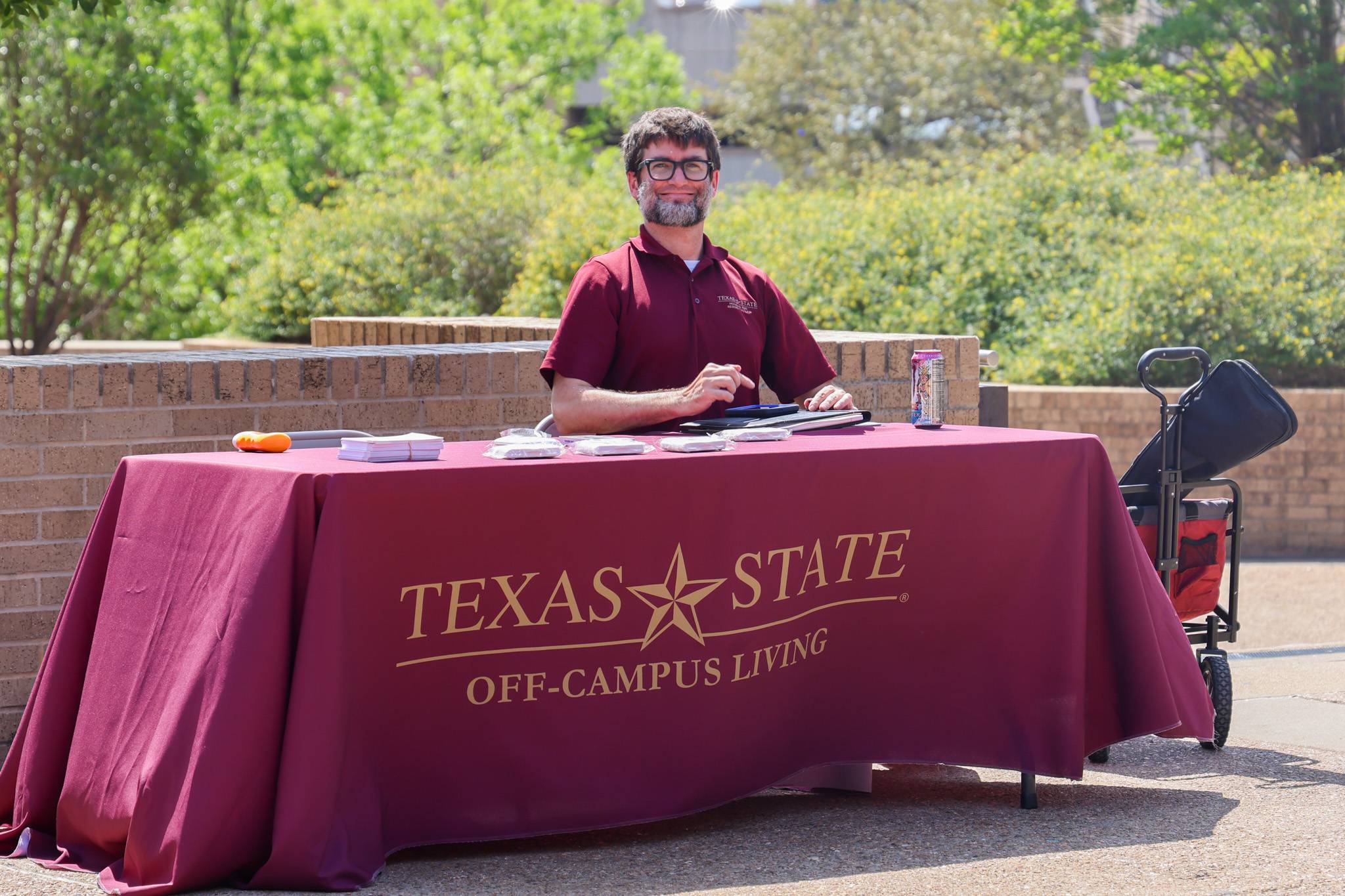 staff member sitting at a table for off-campus living