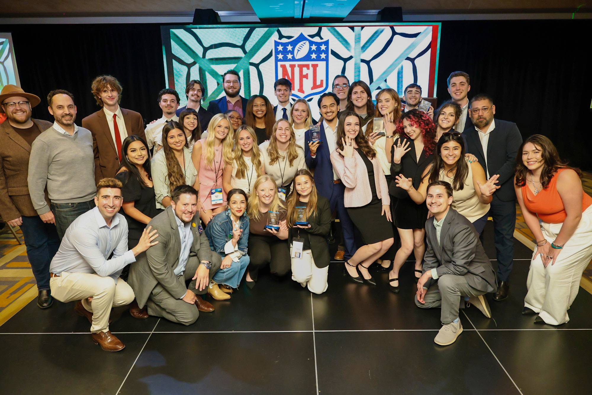 The Texas State NSAC team, faculty advisors Dr. Mike Devlin and Cimin Cohen, NFL client representatives and AAF District 10 representatives pose following the competition. 