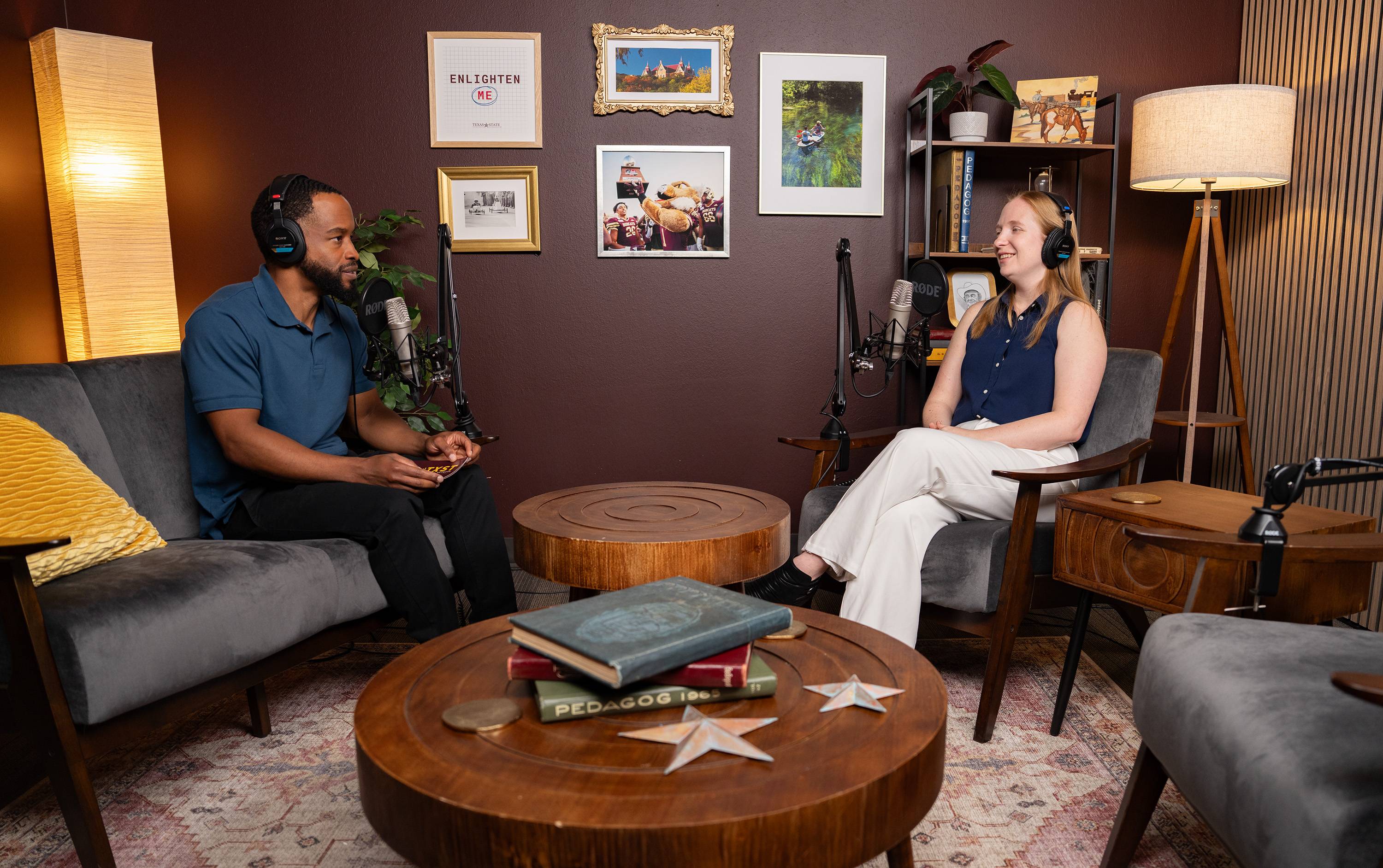 man and female speaking while recording a podcast. they are wearing headphones and speaking into microphones