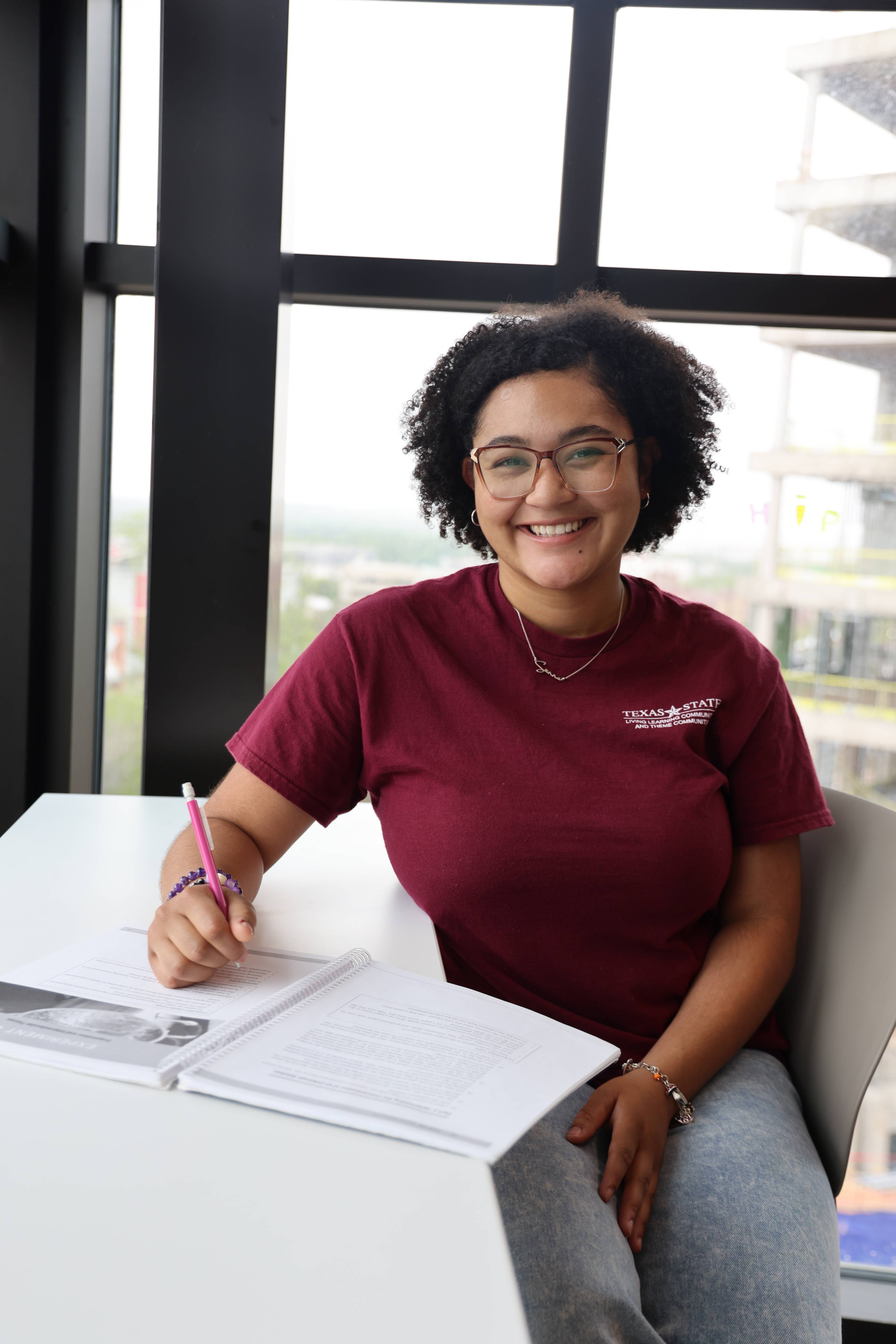 Student sitting at a desk with a notebook