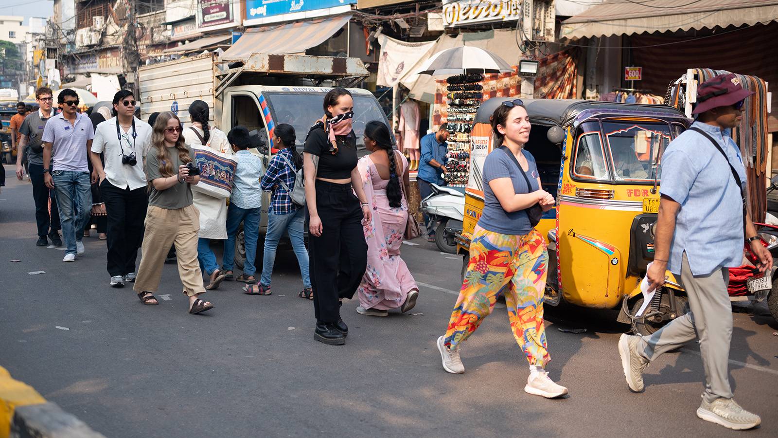 group of McCoy College students and the dean walking through the streets of India