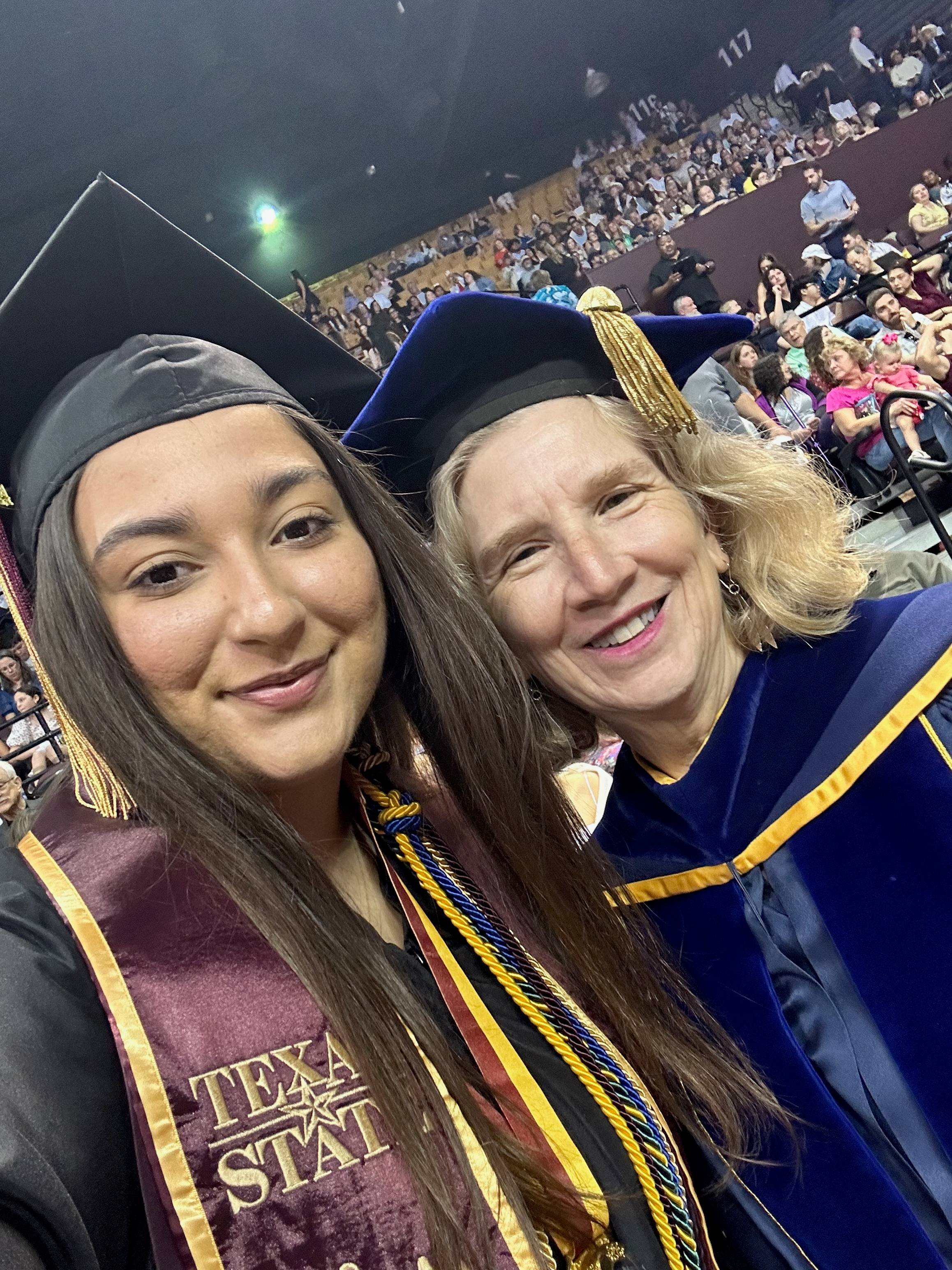 two women take selfie during graduation ceremony