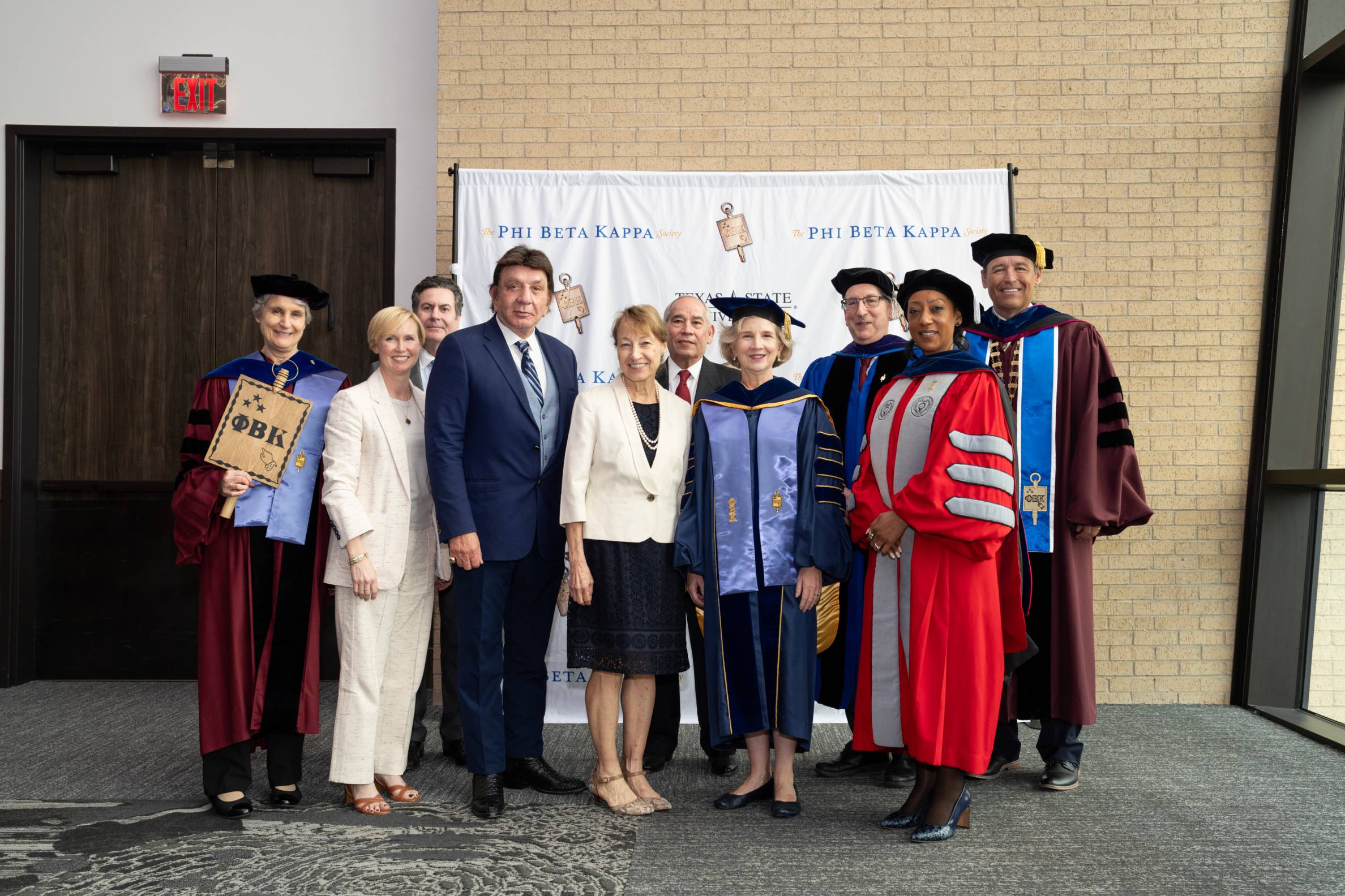 group of people in graduation regalia celebrating at a Phi Betta Kappa event