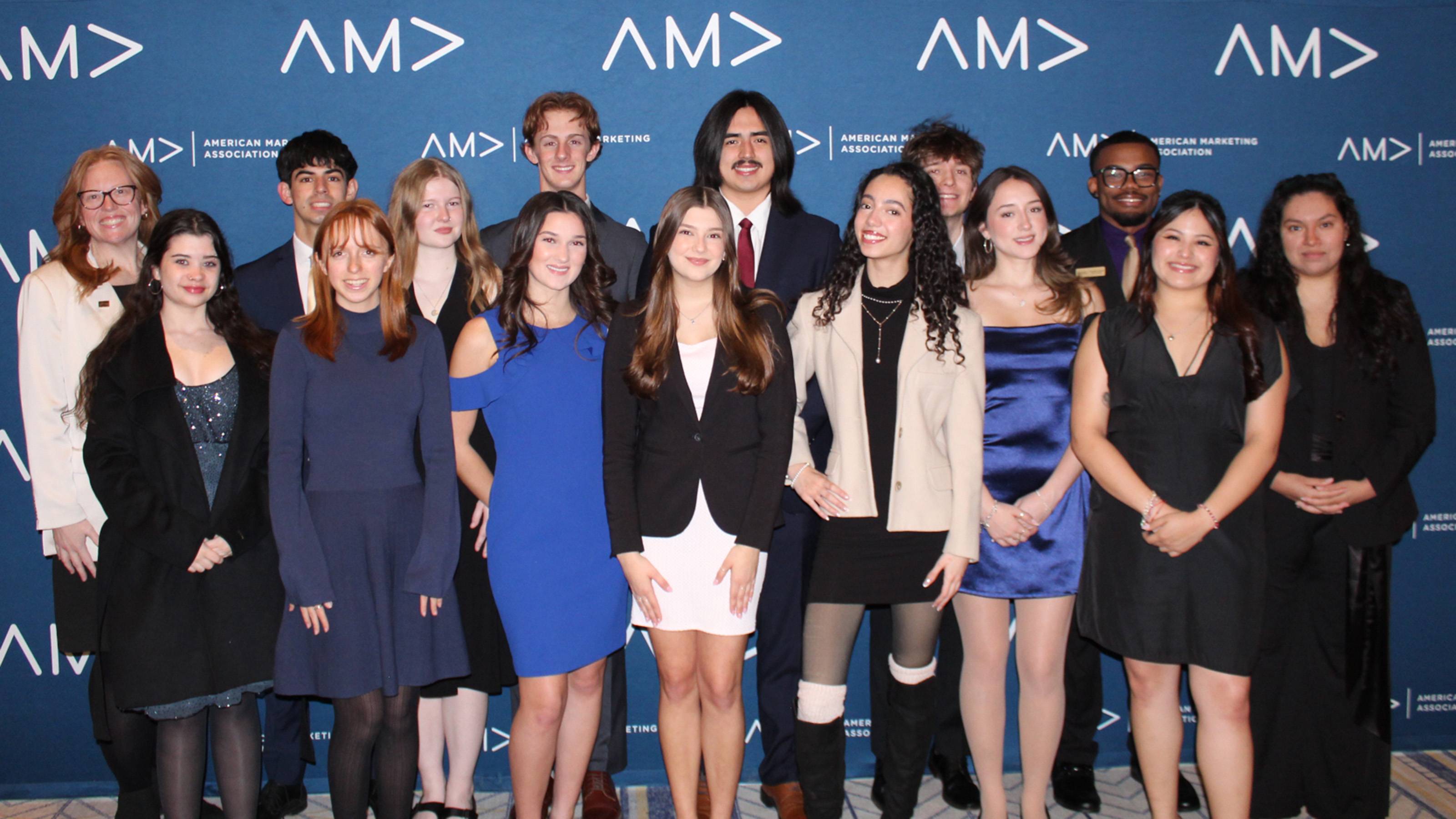 Fifteen individuals posing at a conference event