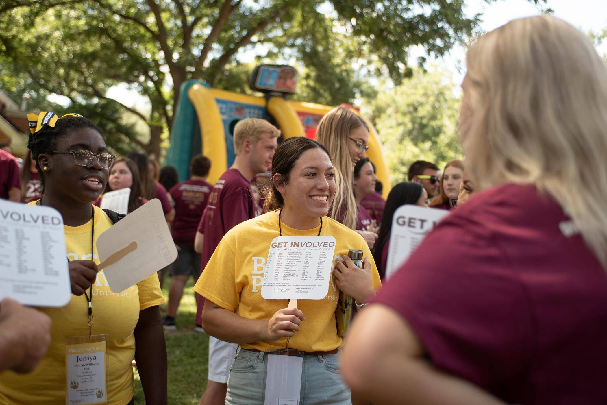 Students chat with an organizer at a campus event.