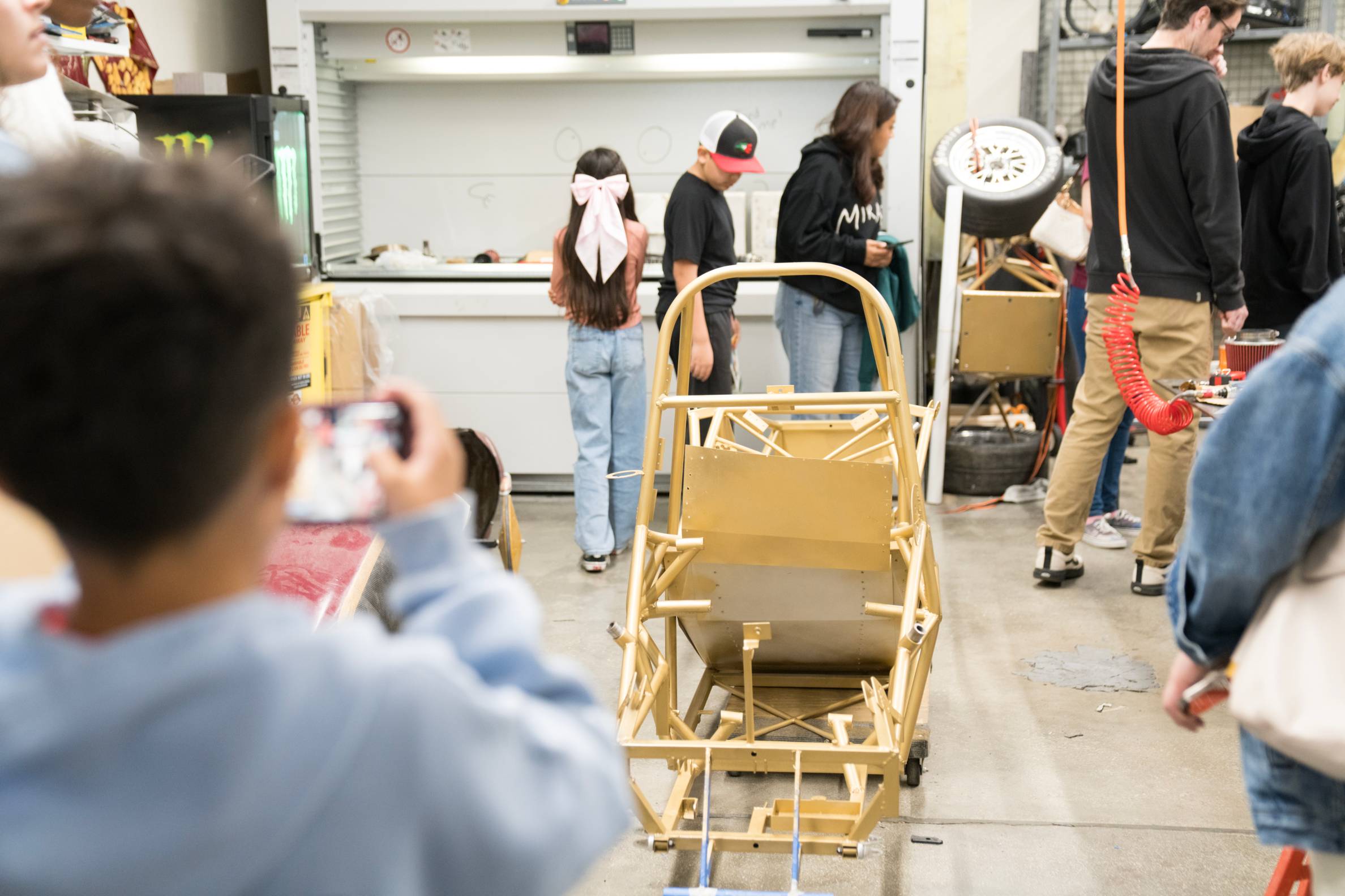 young boy takes photo of metal frame
