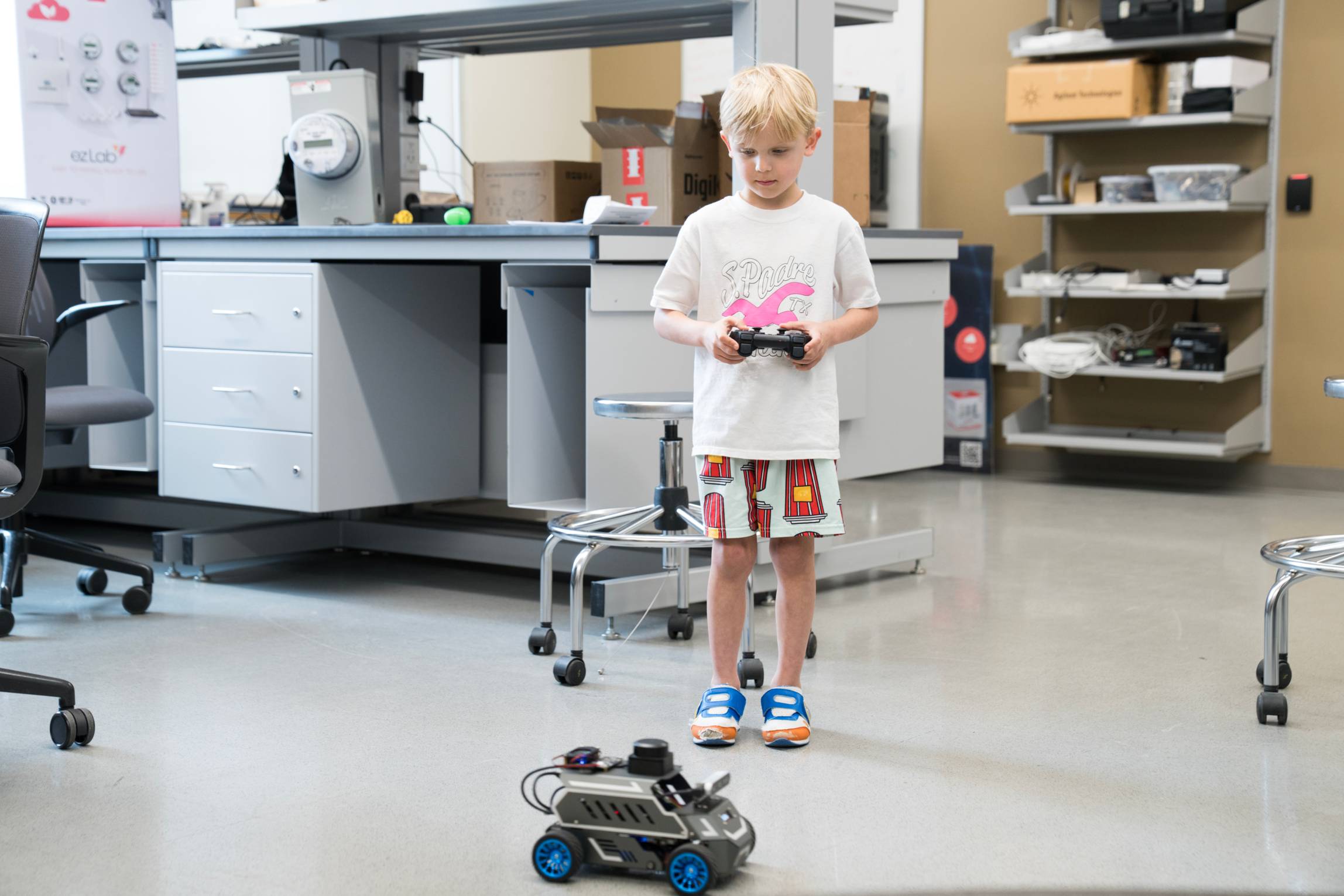 young boy plays with motorized car toy