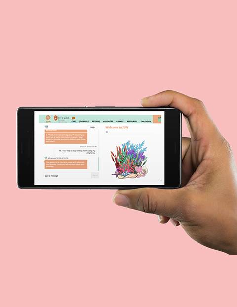 Pink background with hand holding a mobile screen