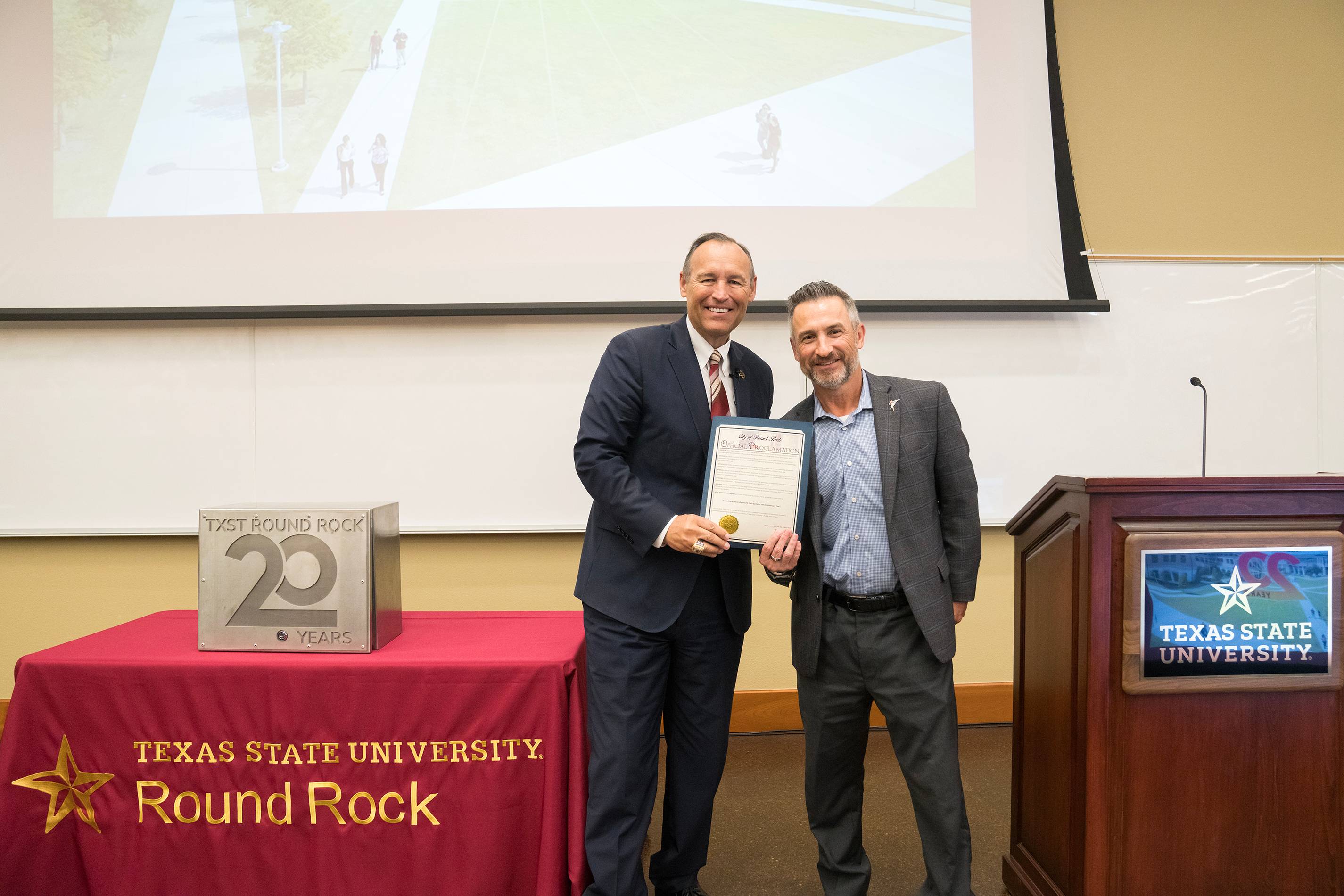two men hold up proclamation 
