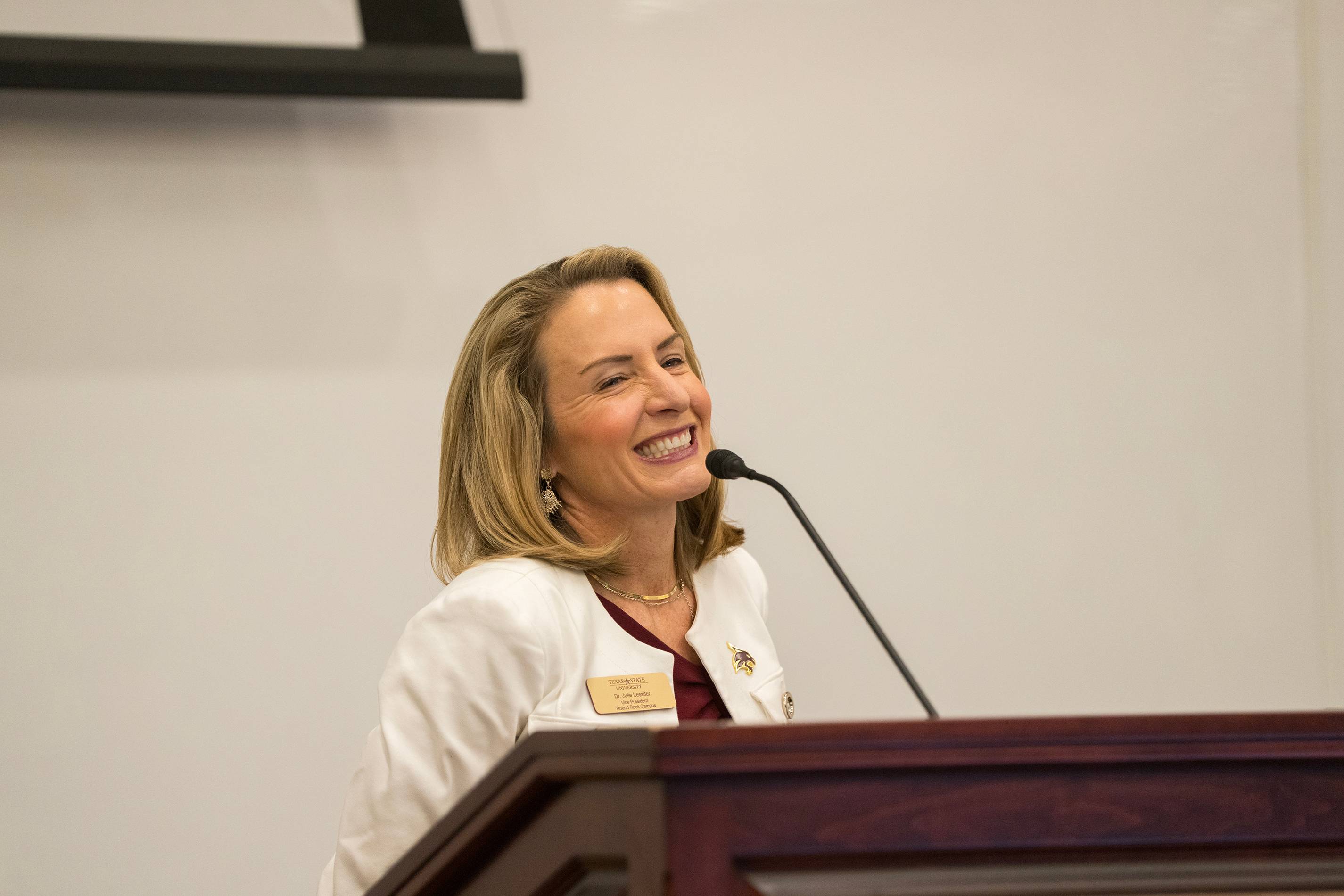 Julie Lessiter speaking at podium