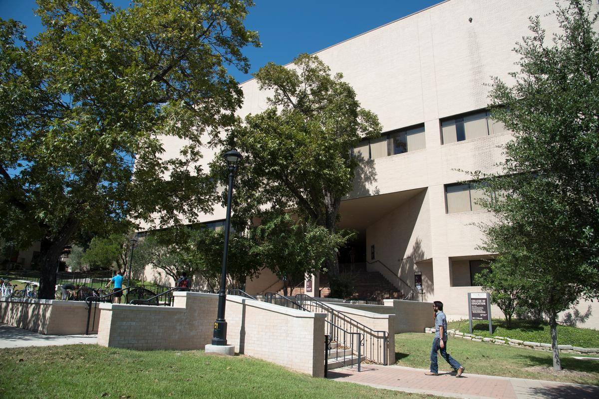 a student walking in front of the education building